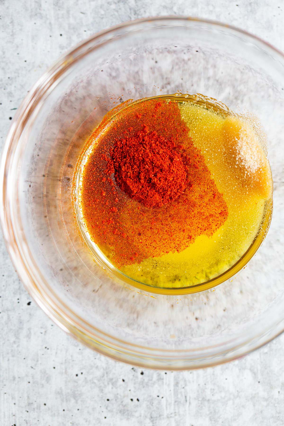 Olive oil and seasonings in a bowl
