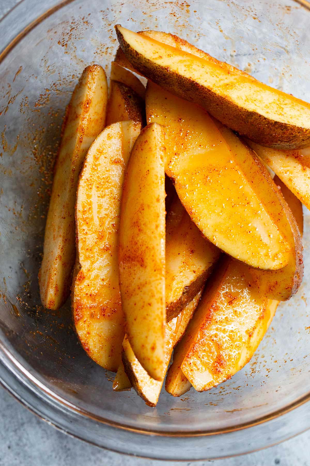 Potato wedges tossed with oil and spices