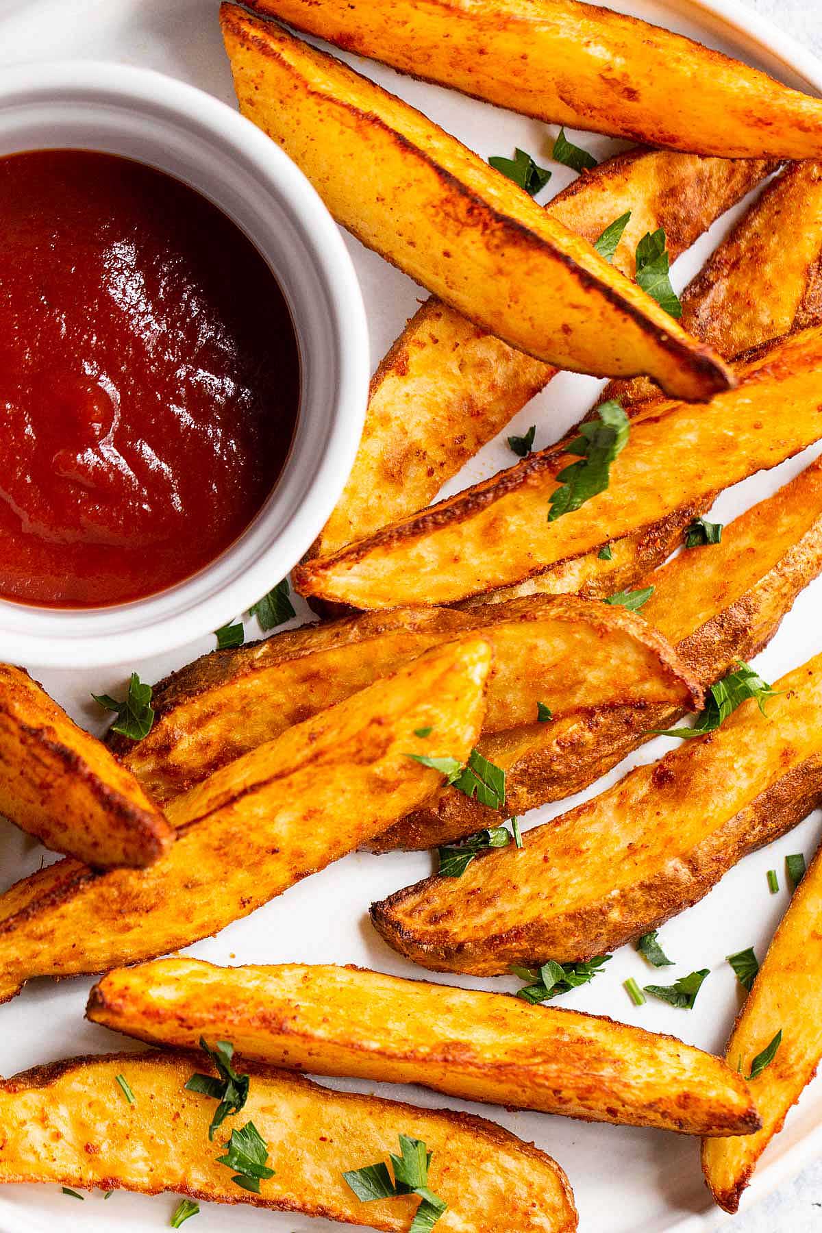 Air fryer potato wedges on a white plate