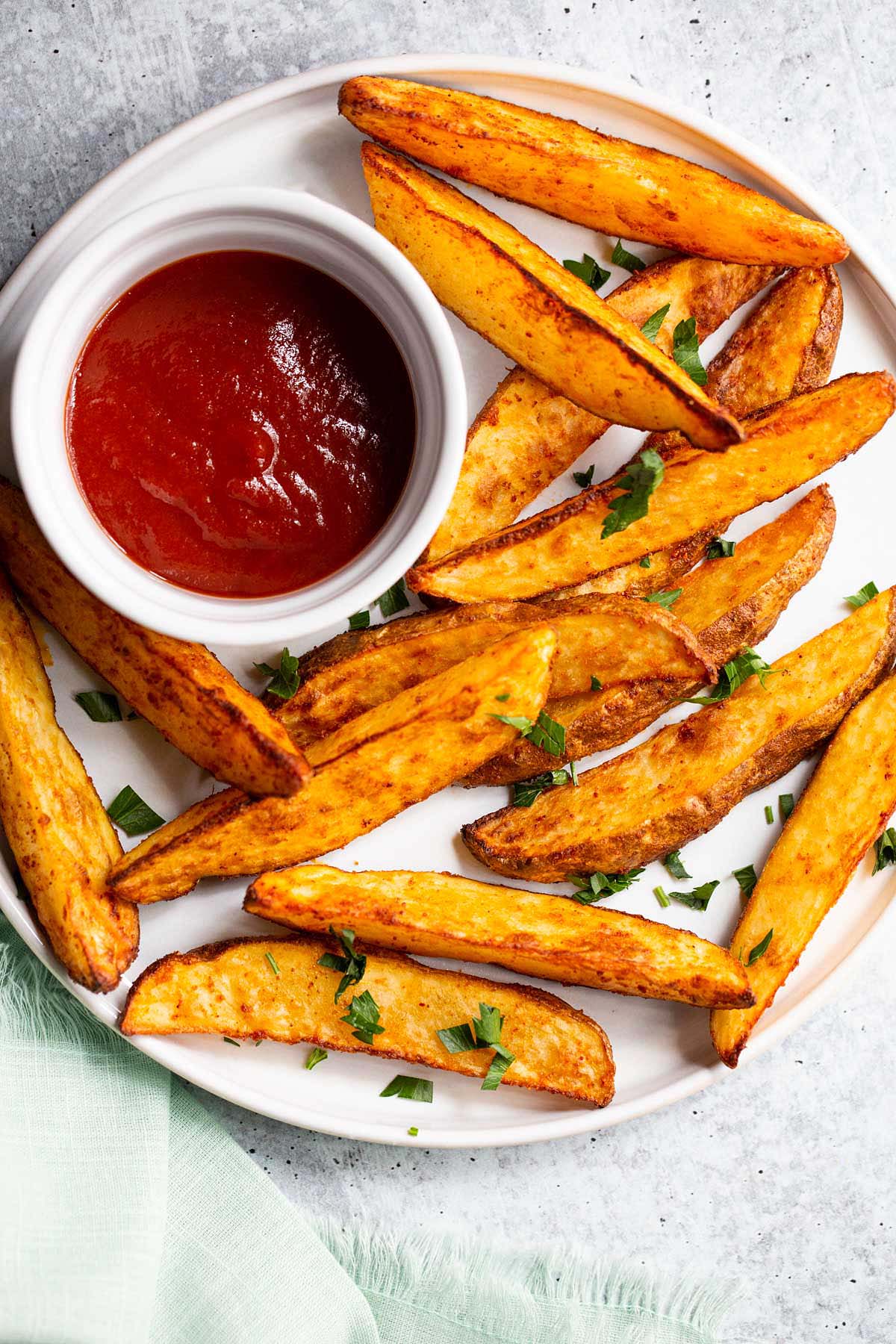 Air fryer potato wedges on a white plate