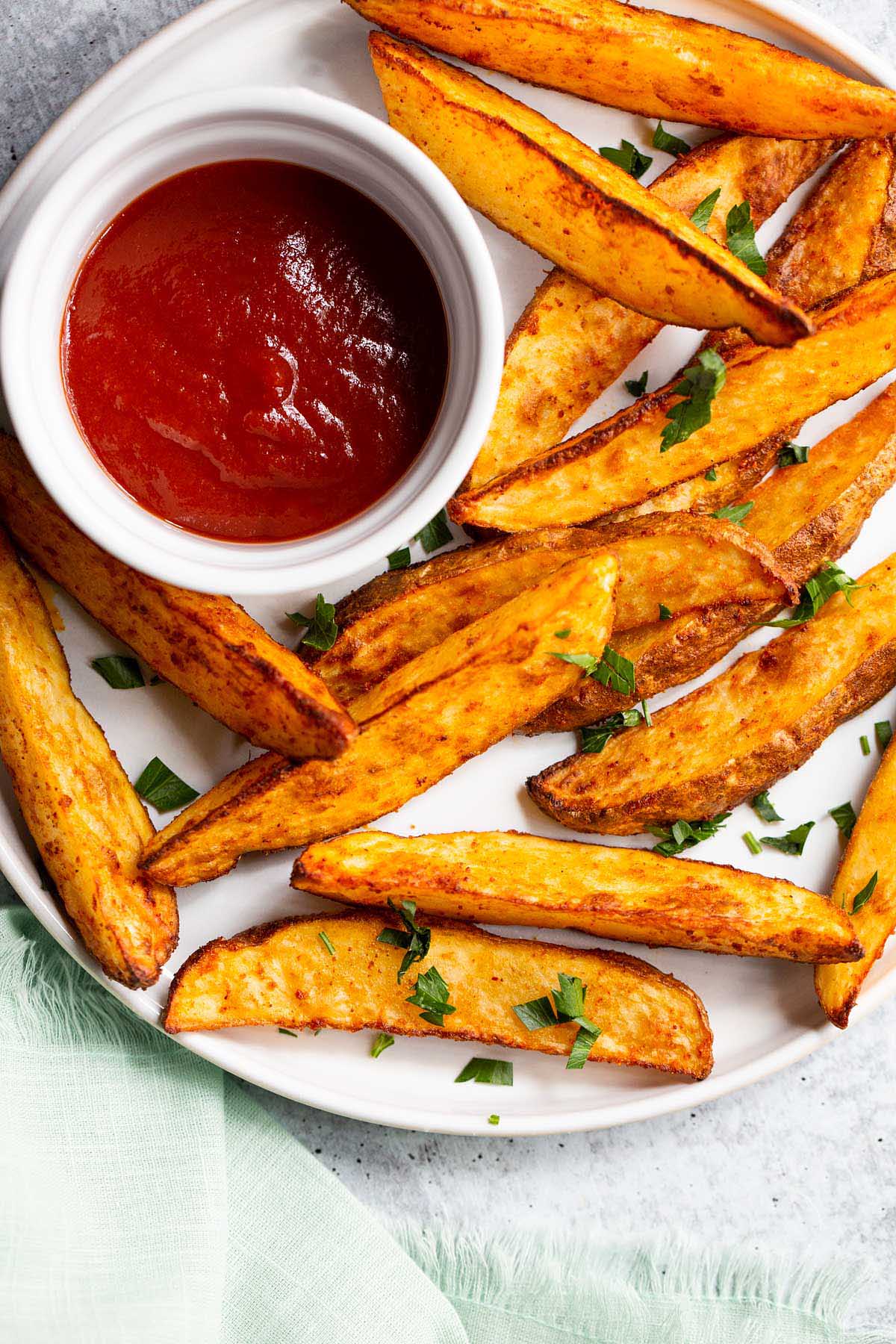 Air fryer potato wedges on a white plate