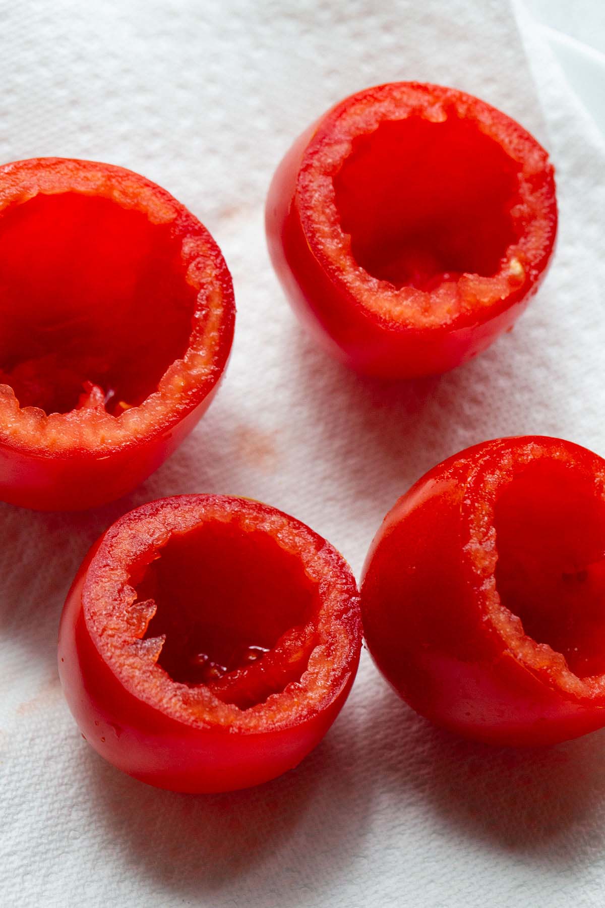 Tomatoes with the insides scooped out.
