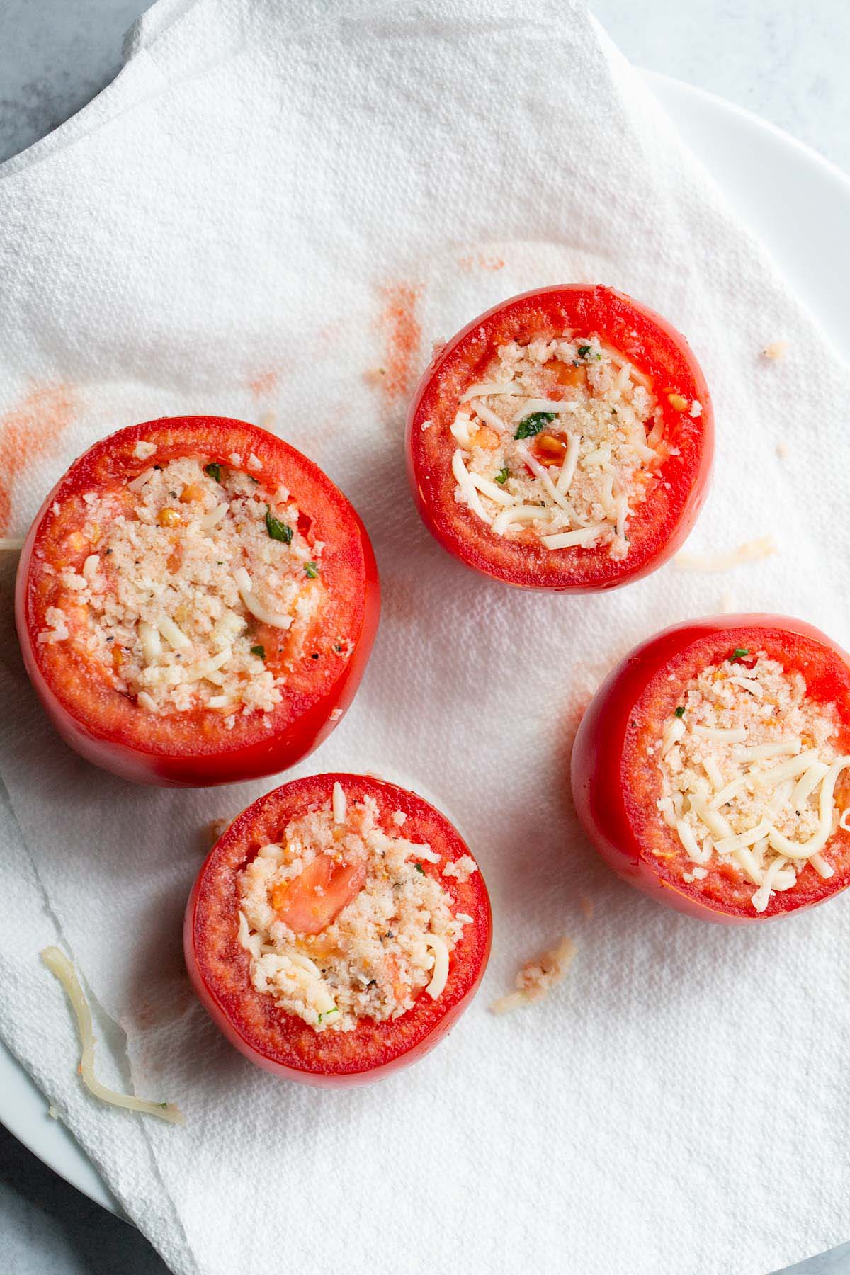Stuffed tomatoes on paper towels.