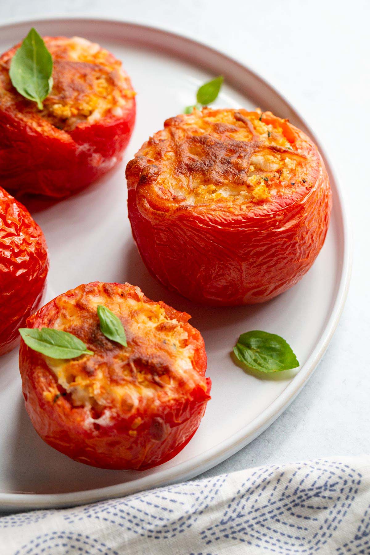 Air fryer stuffed tomatoes on a plate.