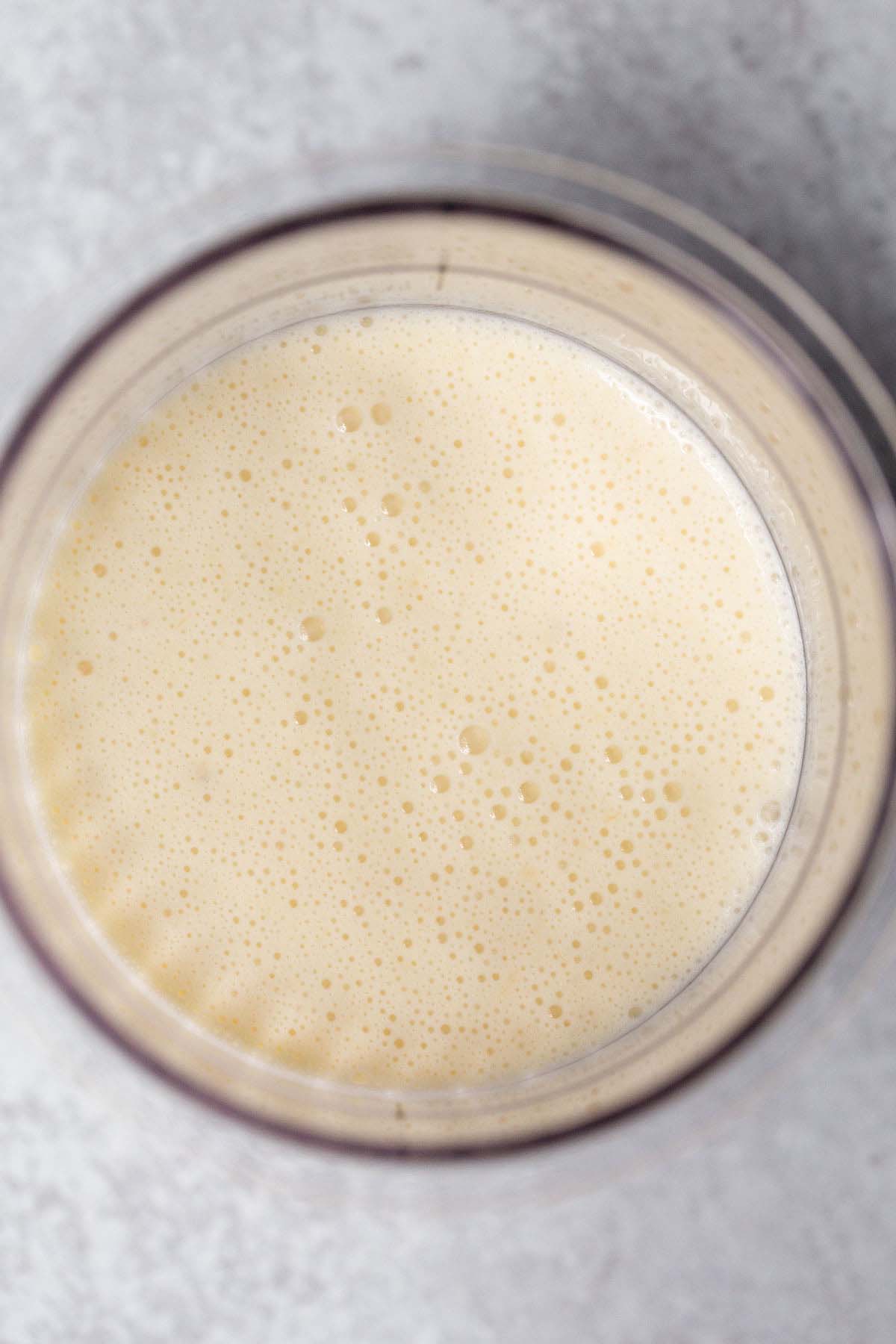 Banana ice cream mixture in Ninja Creami container
