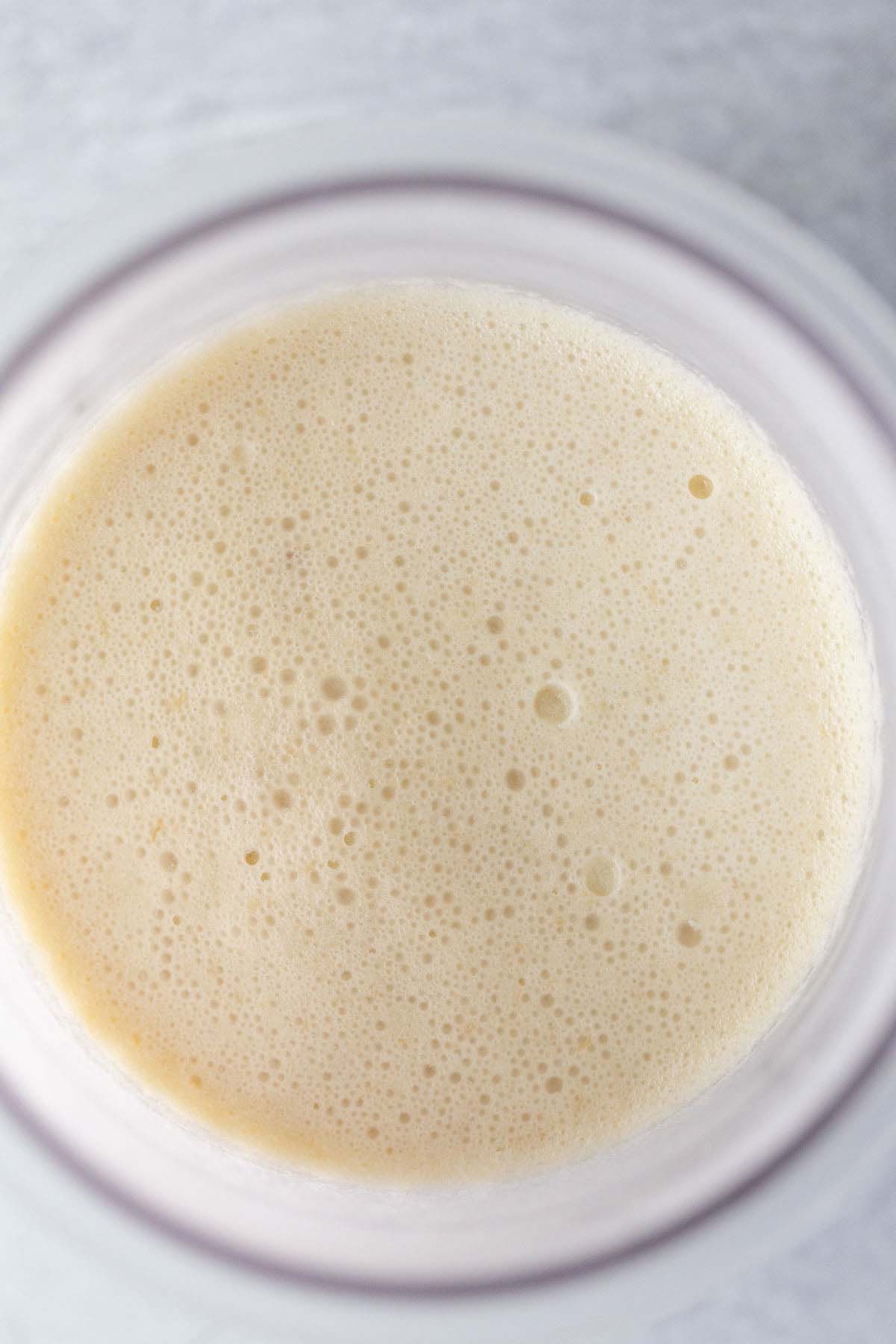 Frozen banana ice cream in Ninja Creami container