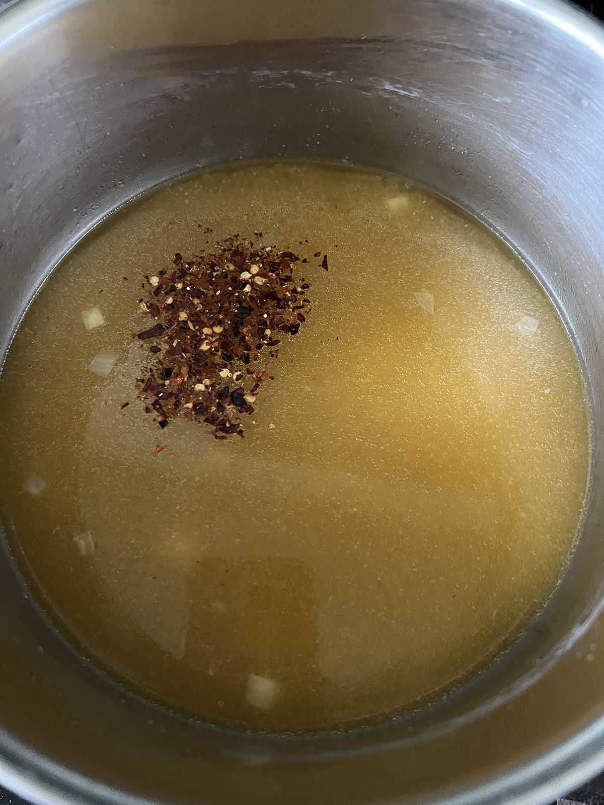 Red peper flakes and spices in soup