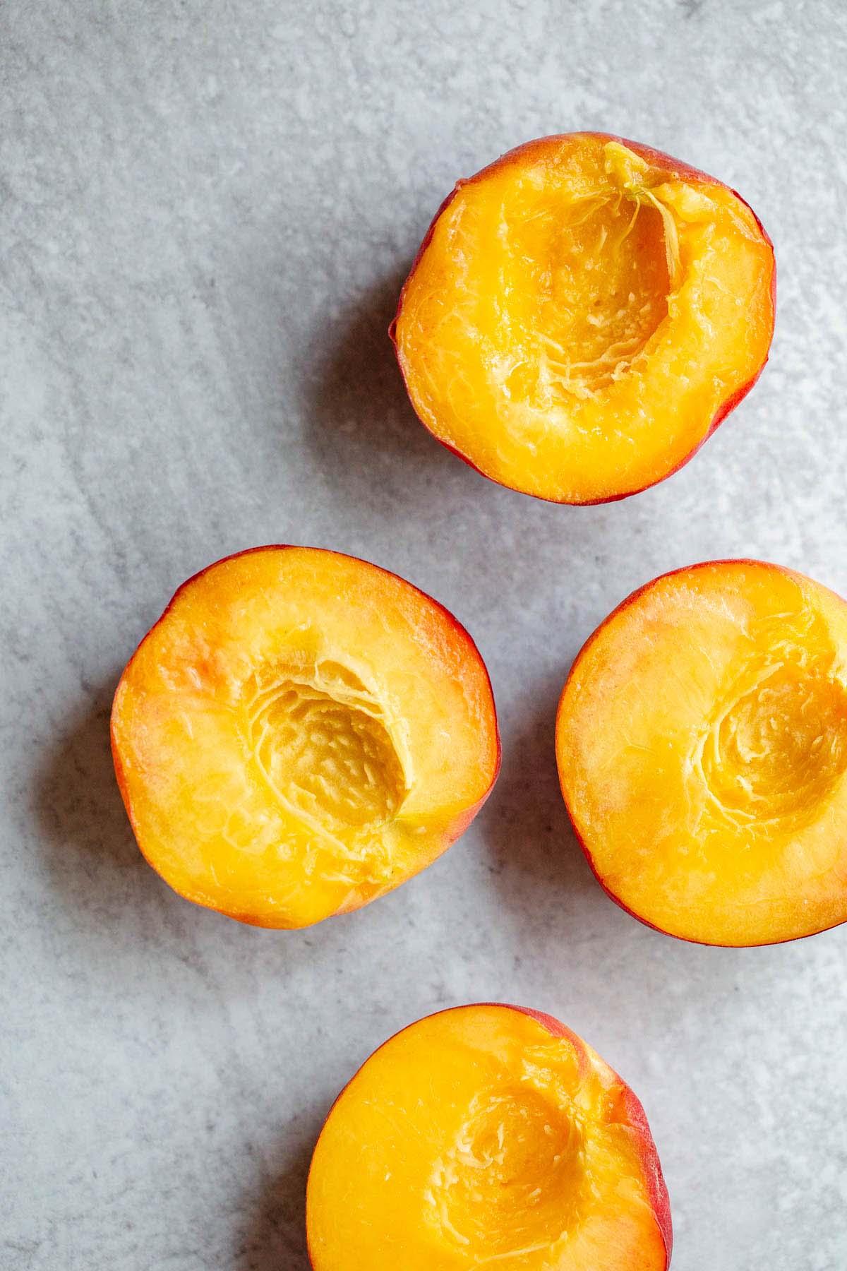 Peaches sliced in half and pitted