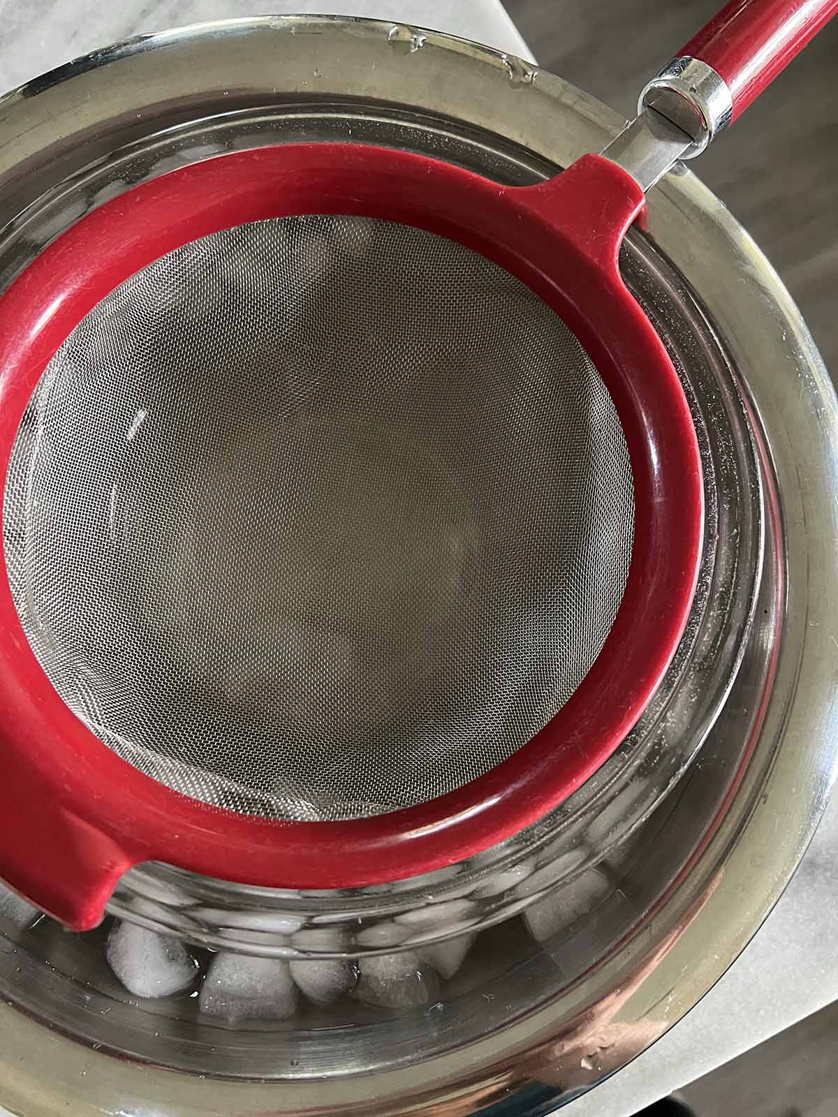 Mesh strainer set up for ice cream