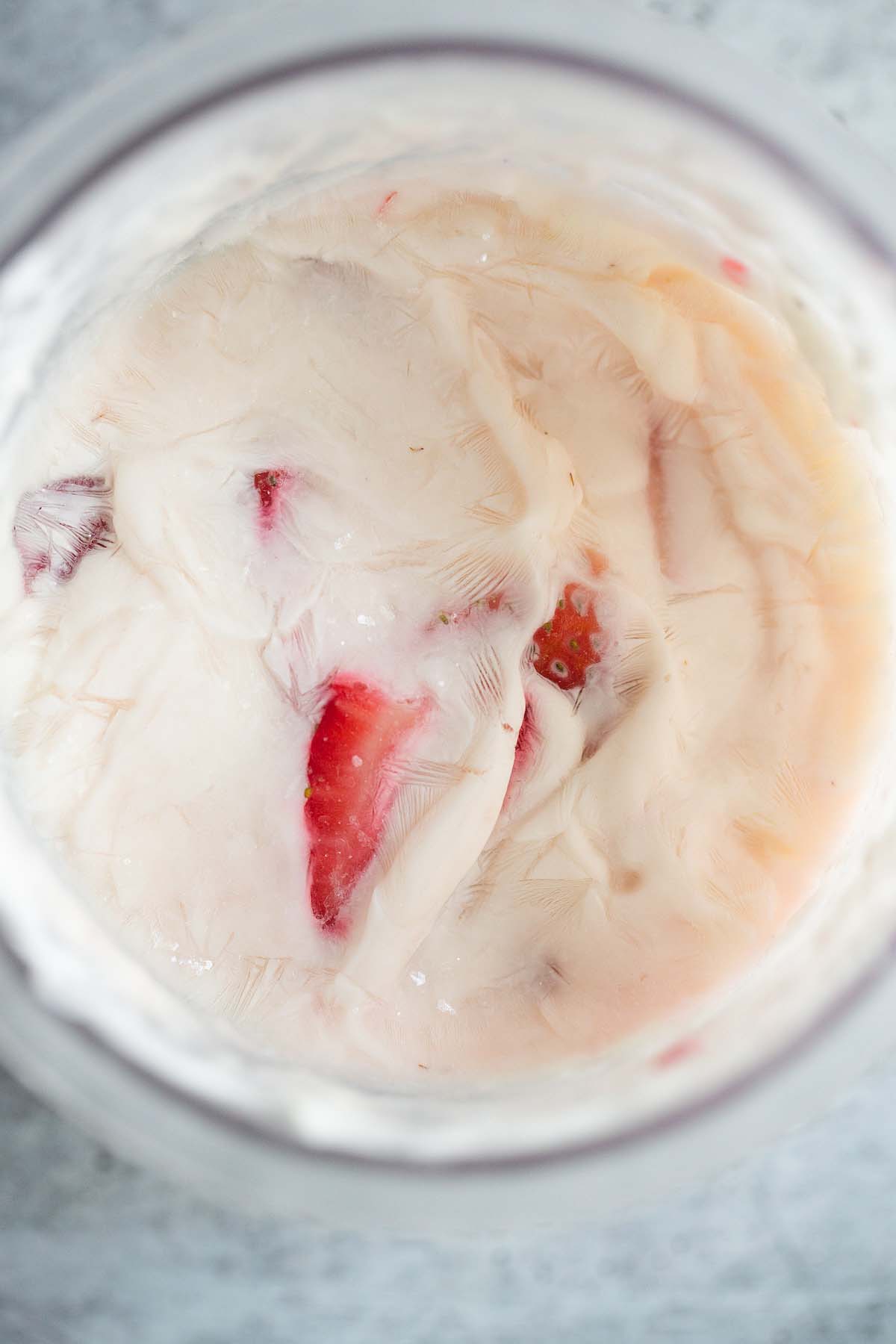 Frozen strawberry yogurt creami in creami container