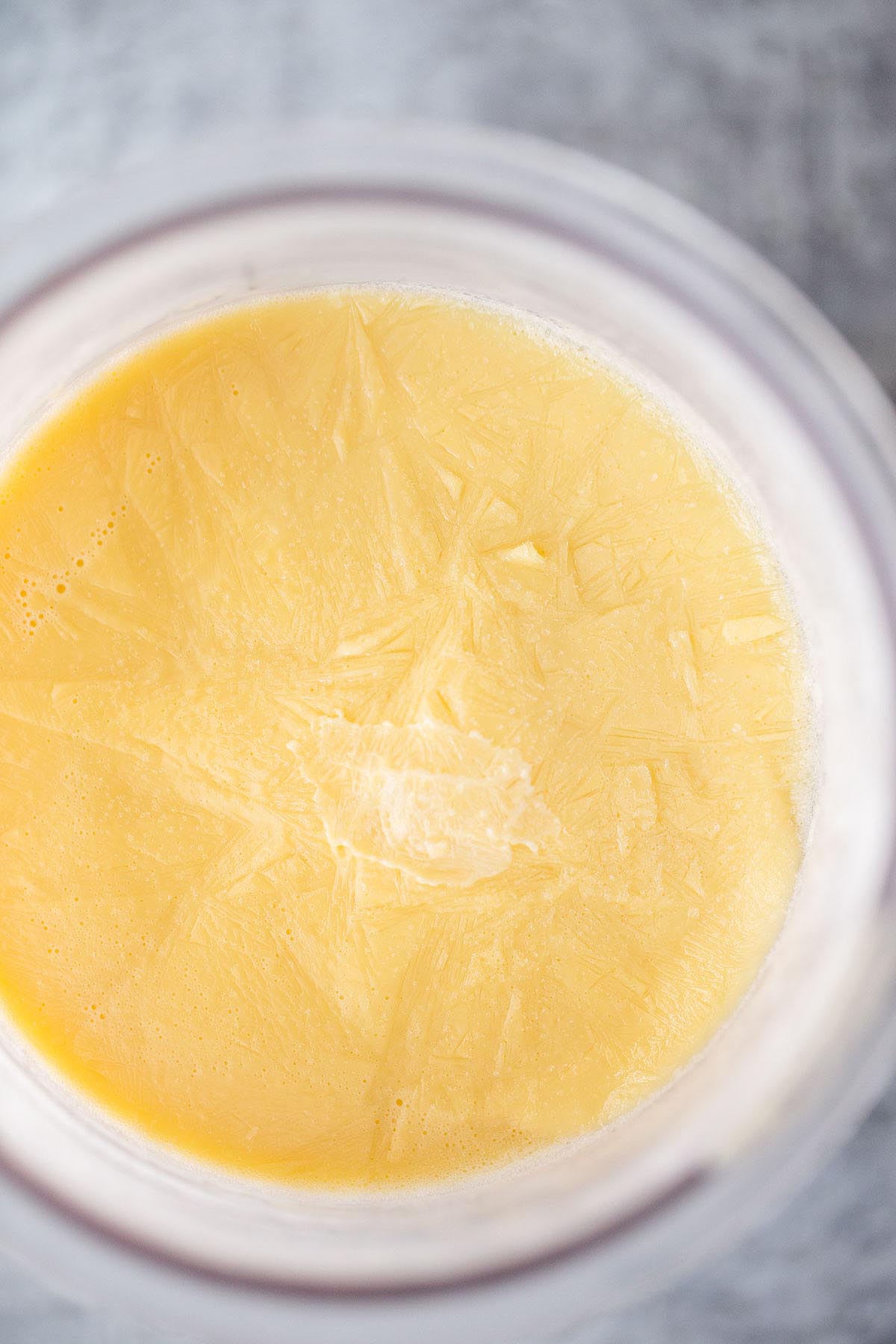 Frozen honey ice cream in Ninja Creami container