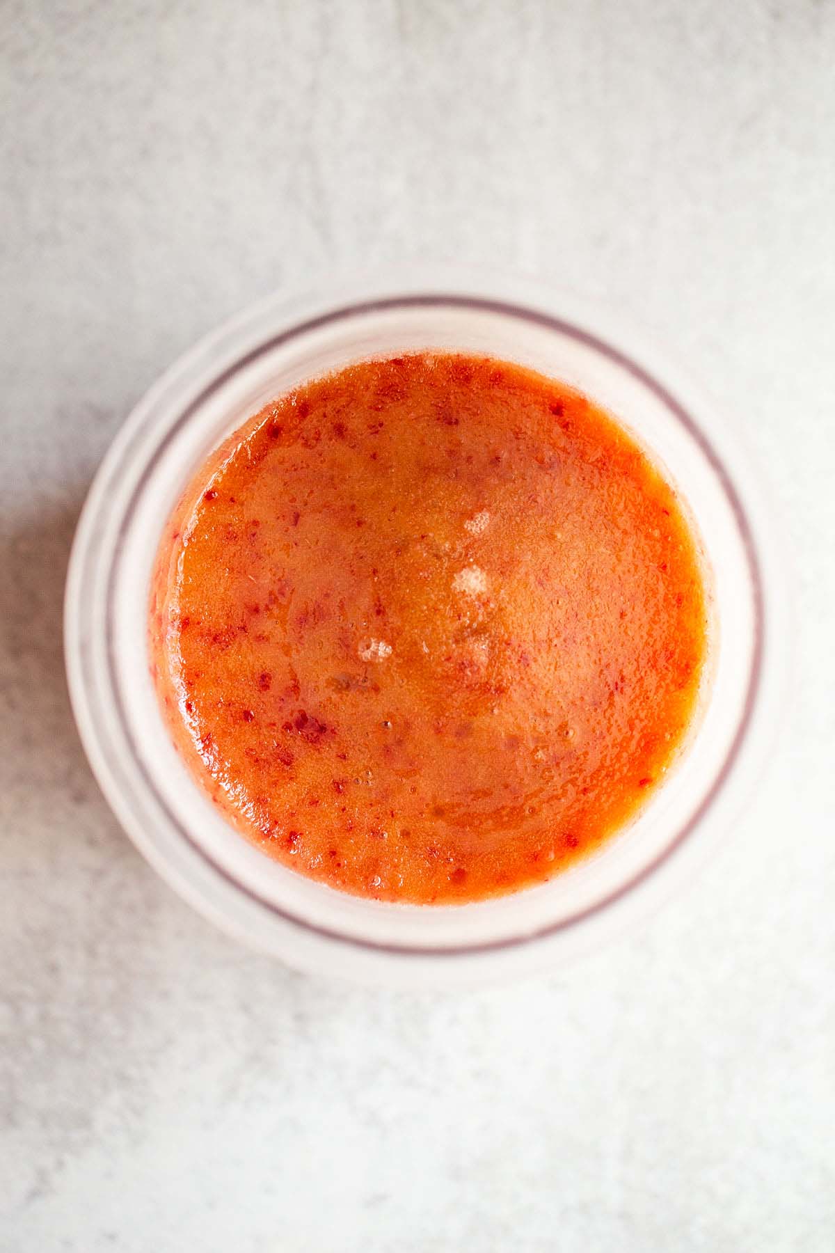 Frozen peach sorbet in Creami container