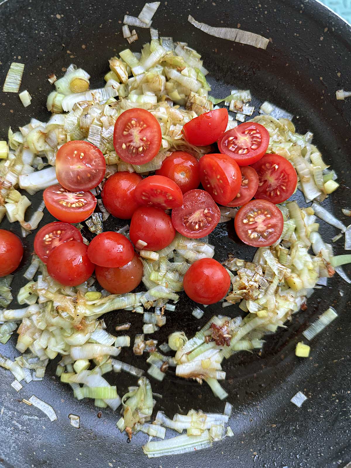 Adding tomatoes to skillet