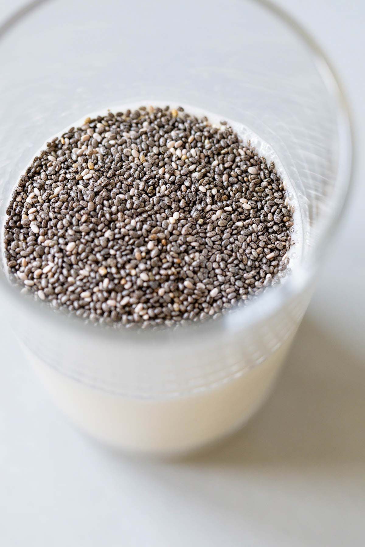 Adding chia seeds to milk.