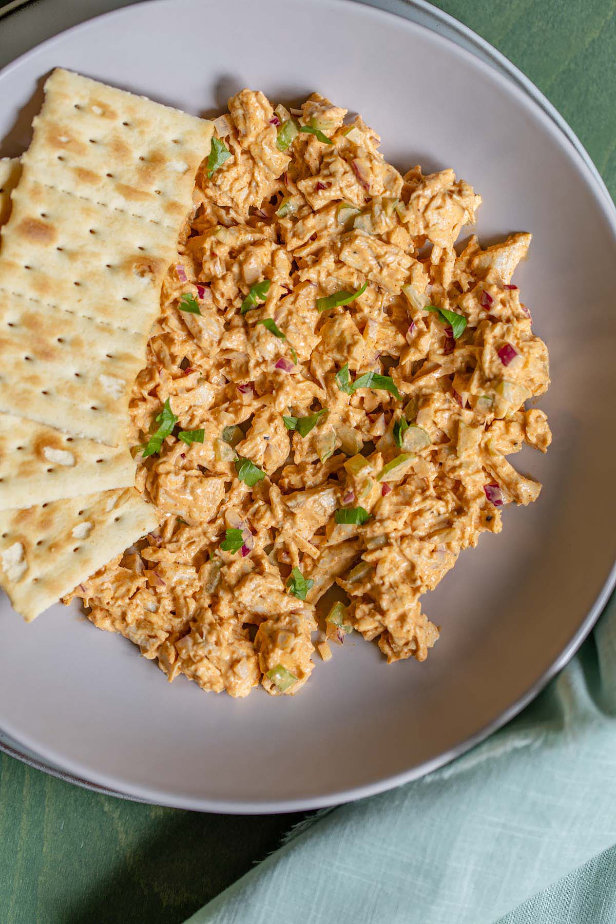 Peri peri chicken salad in a bowl with crackers
