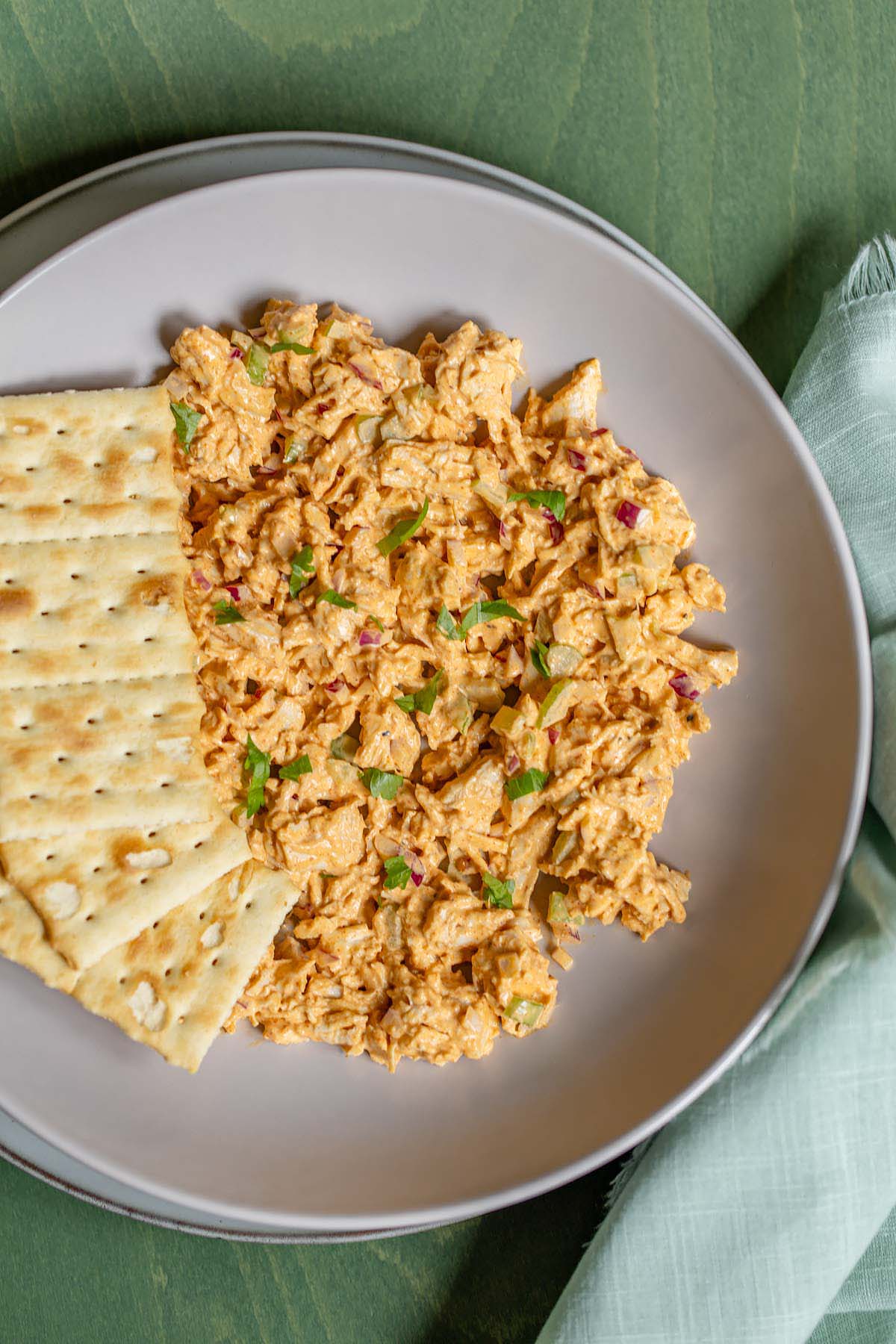 Peri peri chicken salad in a bowl with crackers
