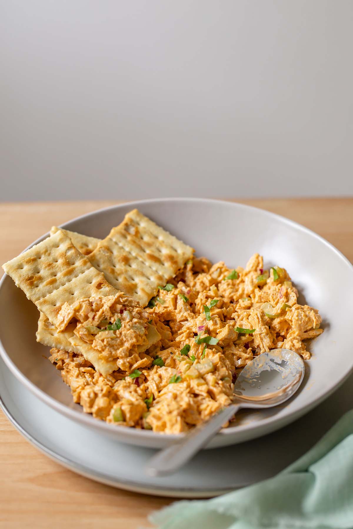 Peri peri chicken salad in a bowl with crackers