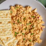 Peri peri chicken salad in a bowl with crackers