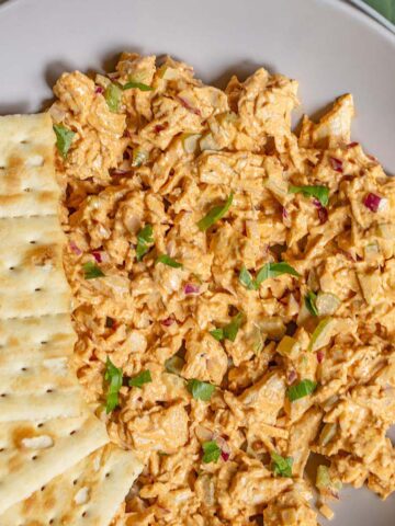 Peri peri chicken salad in a bowl with crackers