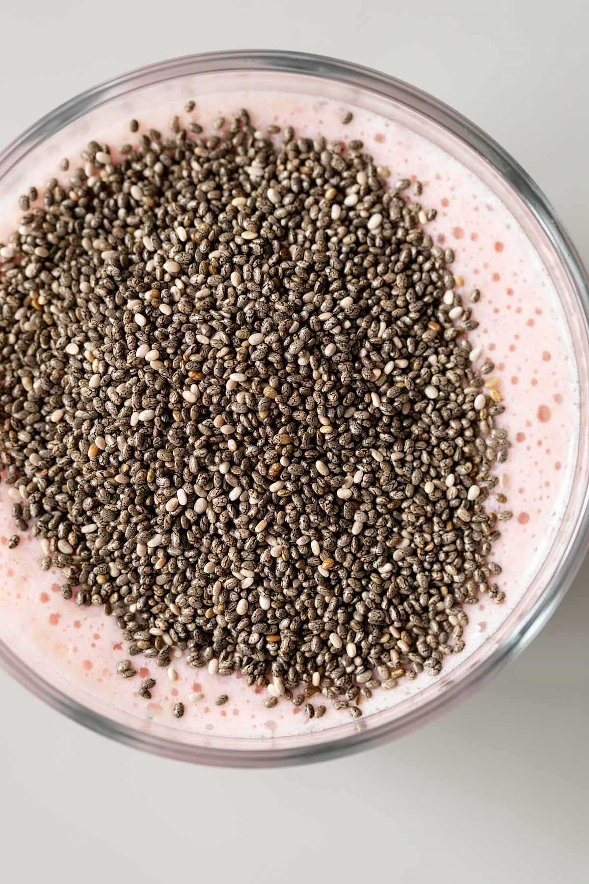 Adding chia seeds to strawberry mixture.