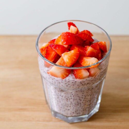 Strawberry chia pudding topped with fresh strawberries.