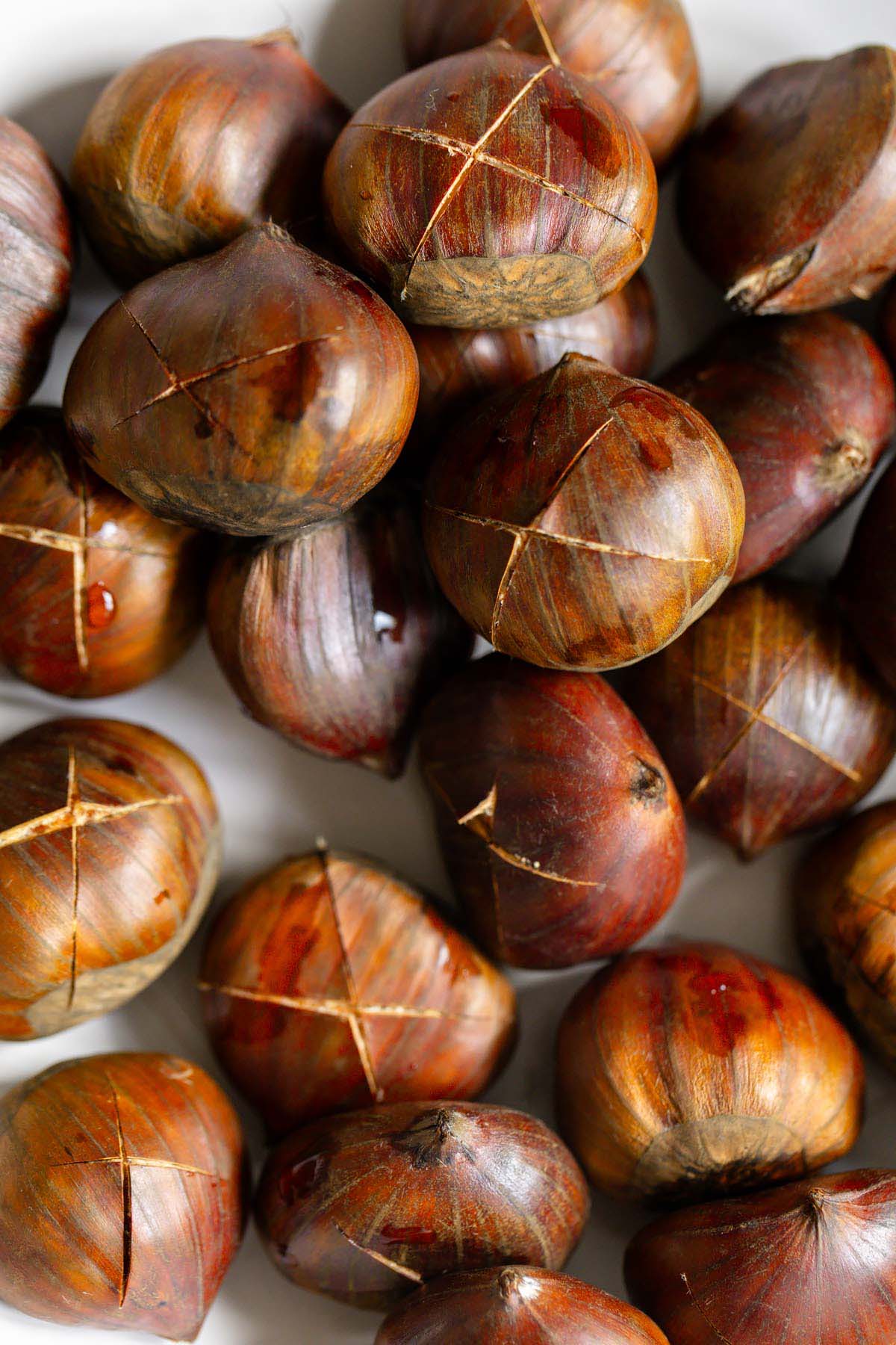 Raw chestnuts scored with an x