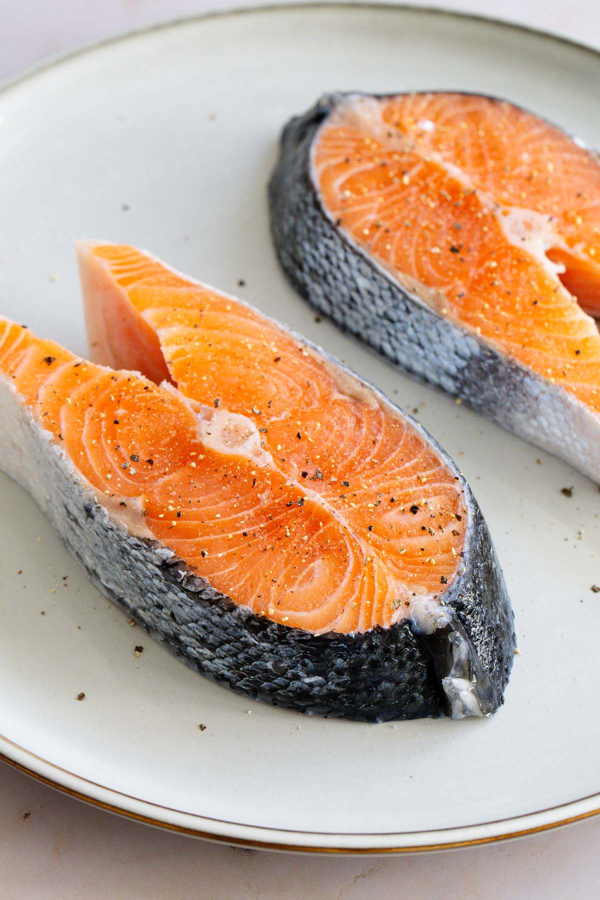 Salmon steaks seasoned with salt and pepper