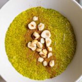 warm golden milk chia pudding topped with cinnamon and hazelnuts