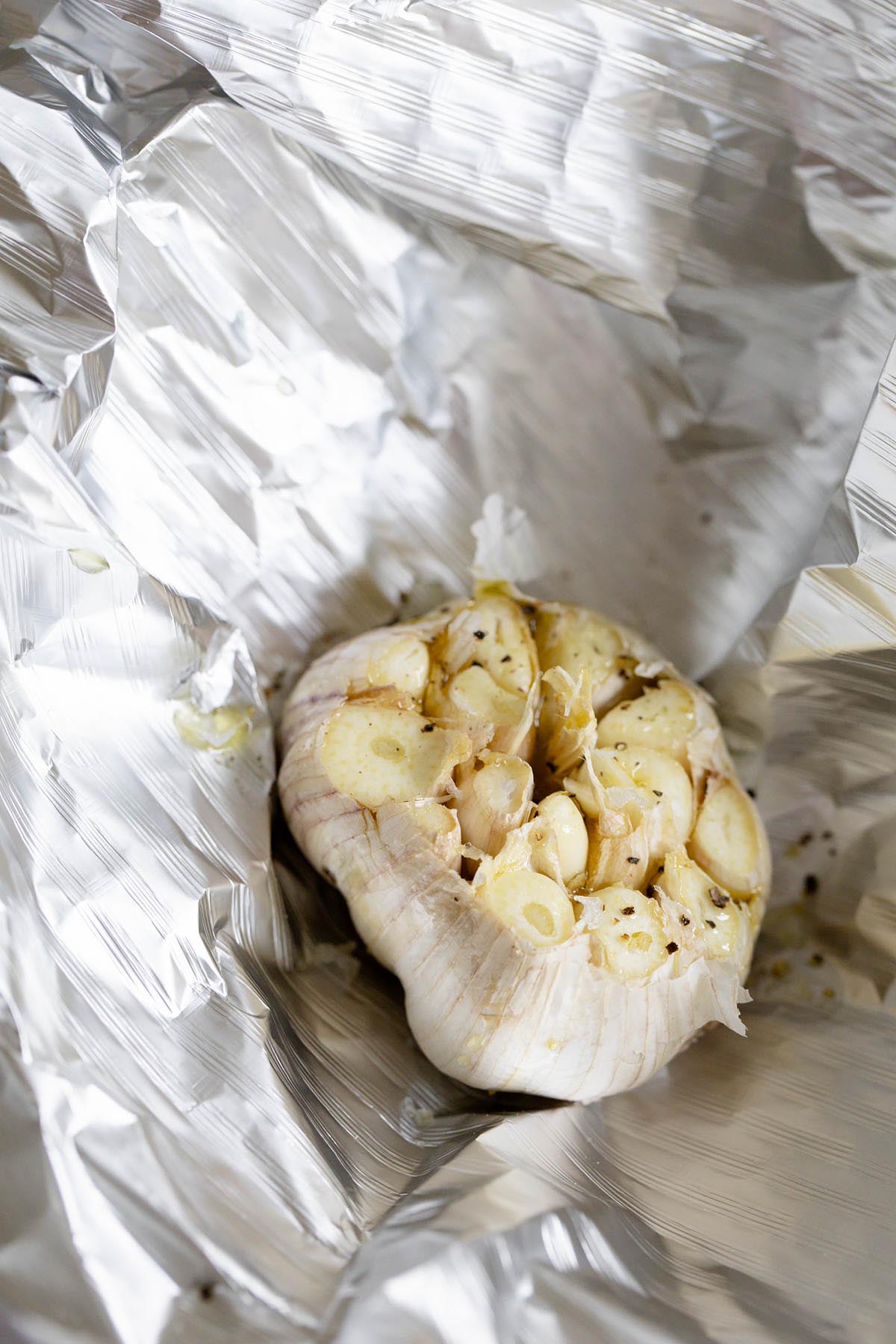 Garlic bulb drizzled with olive oil