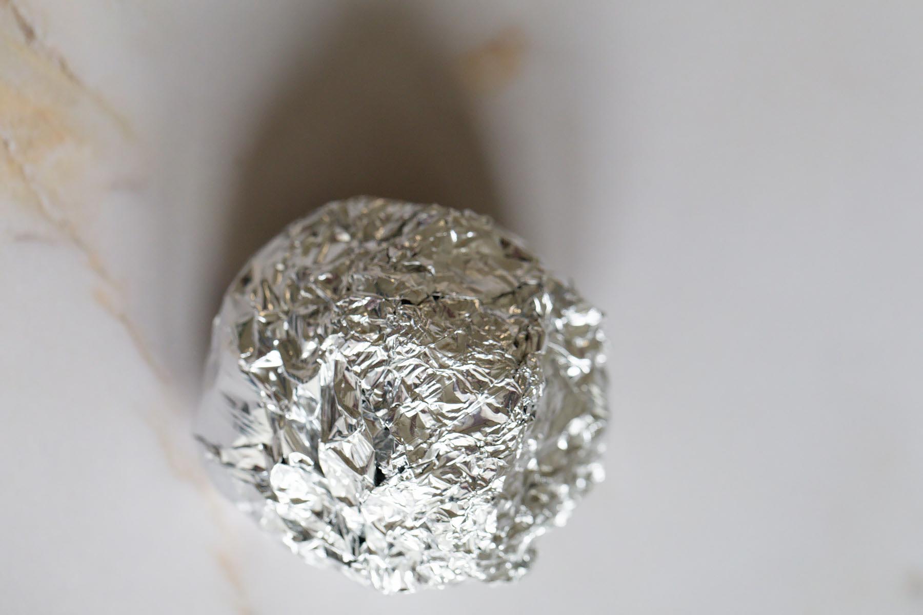 Garlic bulb wrapped in foil