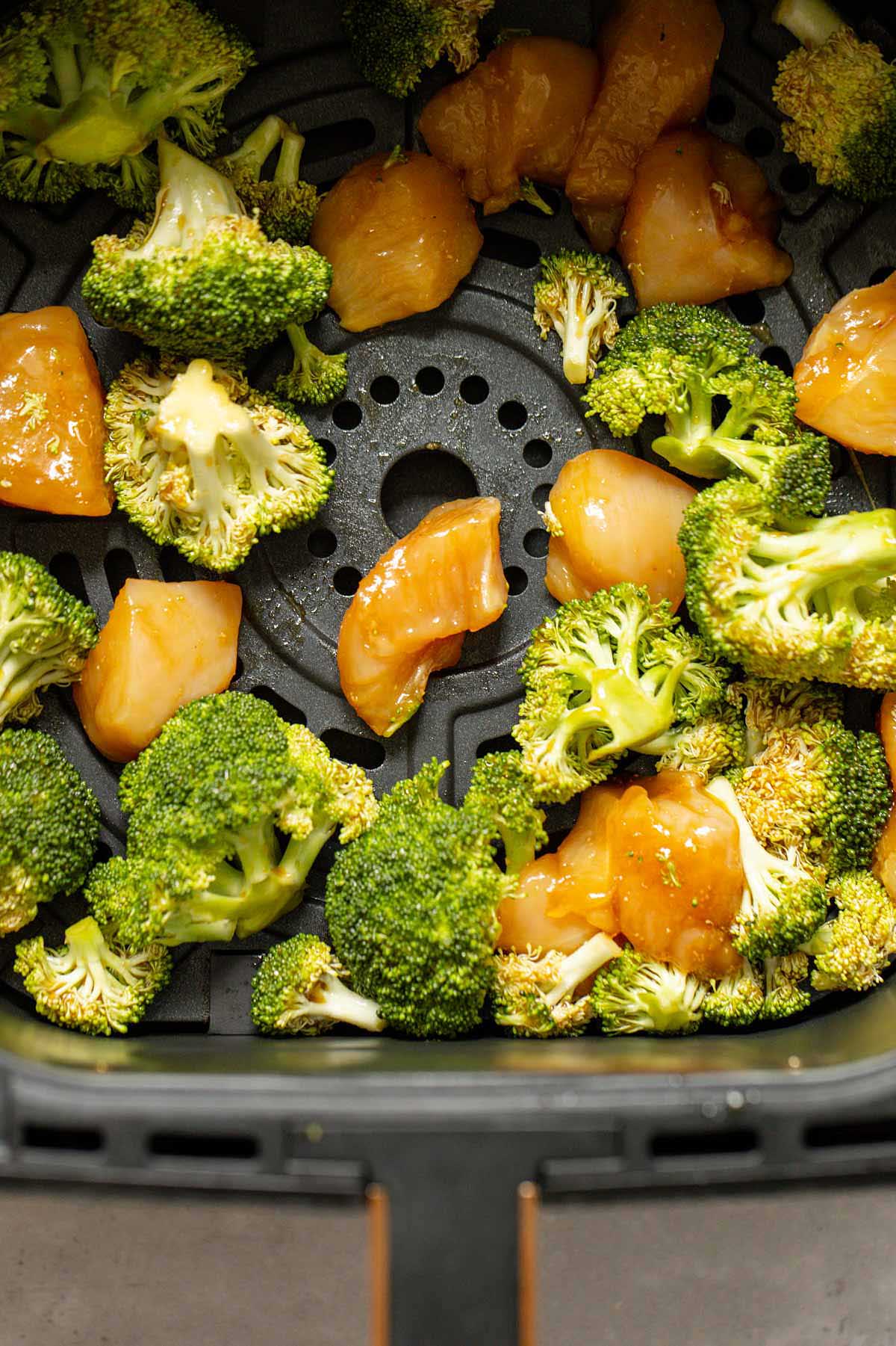 Uncooked chicken and broccoli in the air fryer