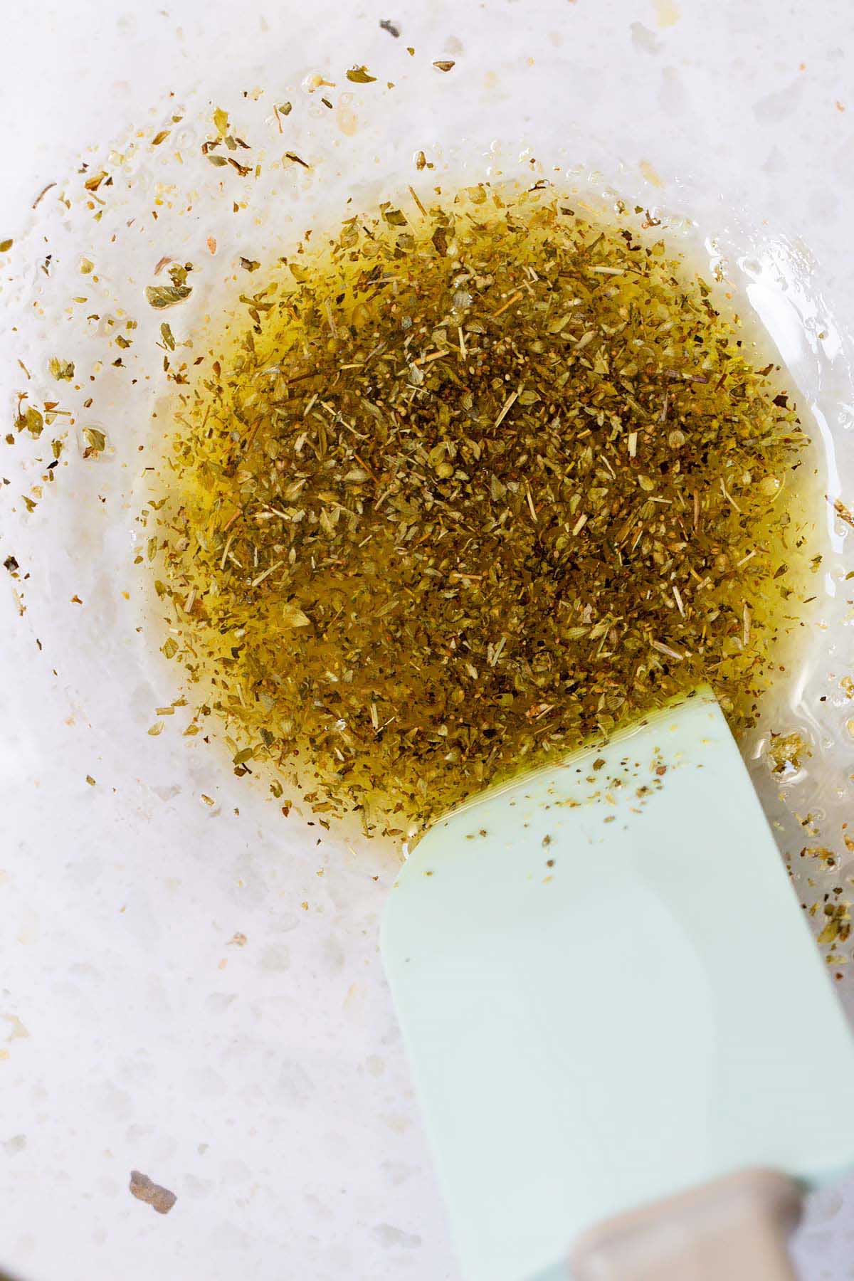 Seasonings and oil mixed together in a bowl