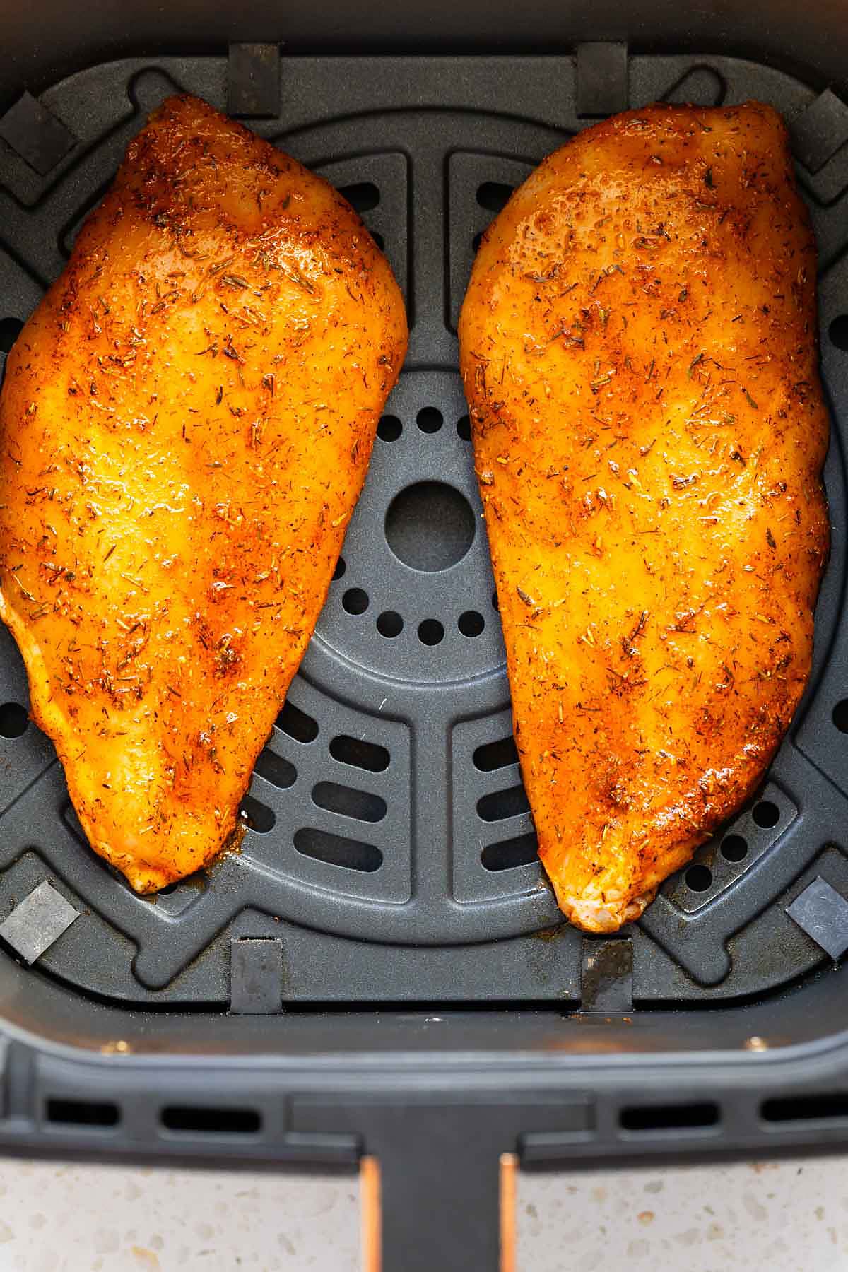 Uncooked chicken breast in air fryer