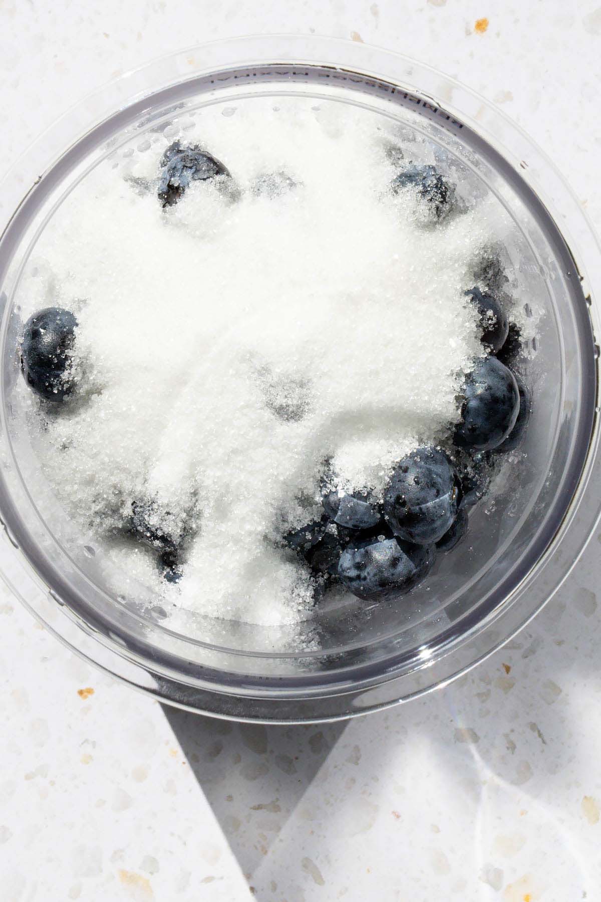 Adding sugar to blueberries