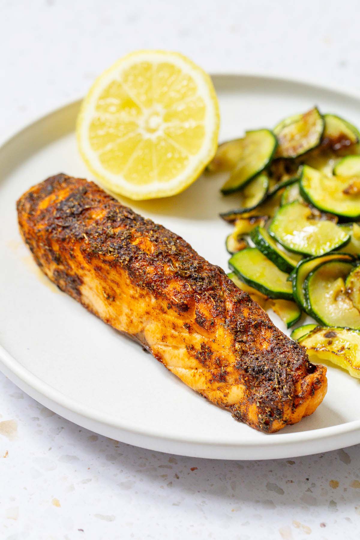 Salmon on a plate with lemon and zucchini