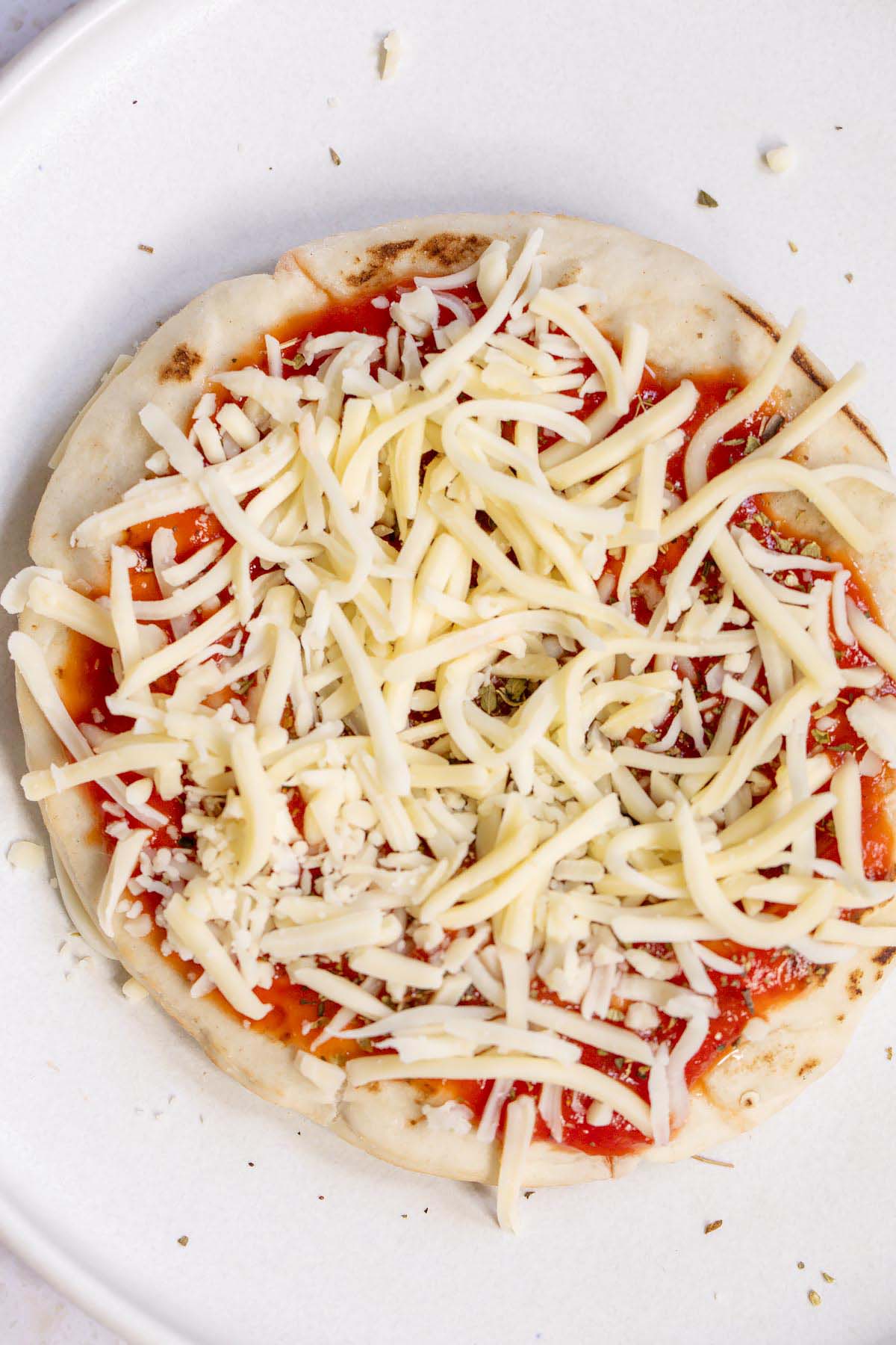Adding cheese to pita