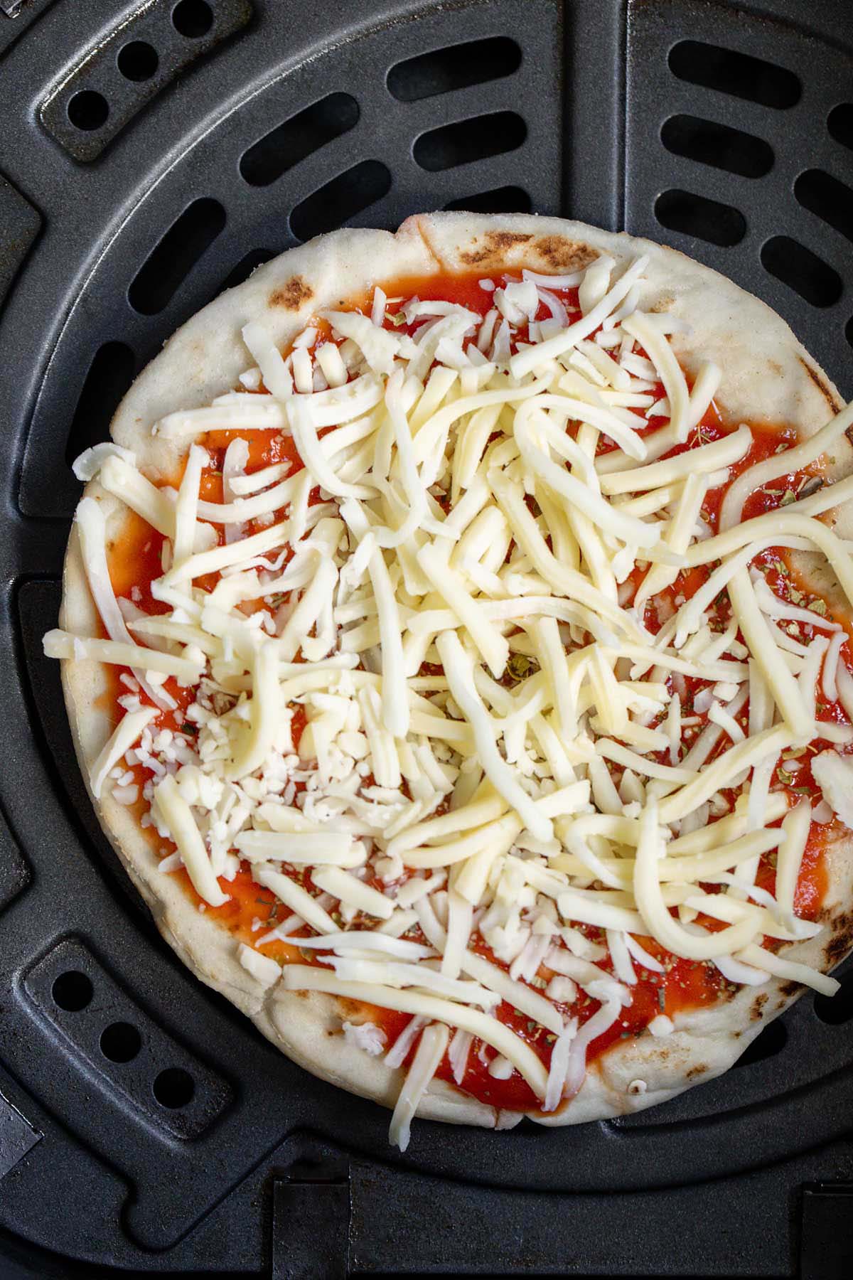Uncooked pita pizza in air fryer