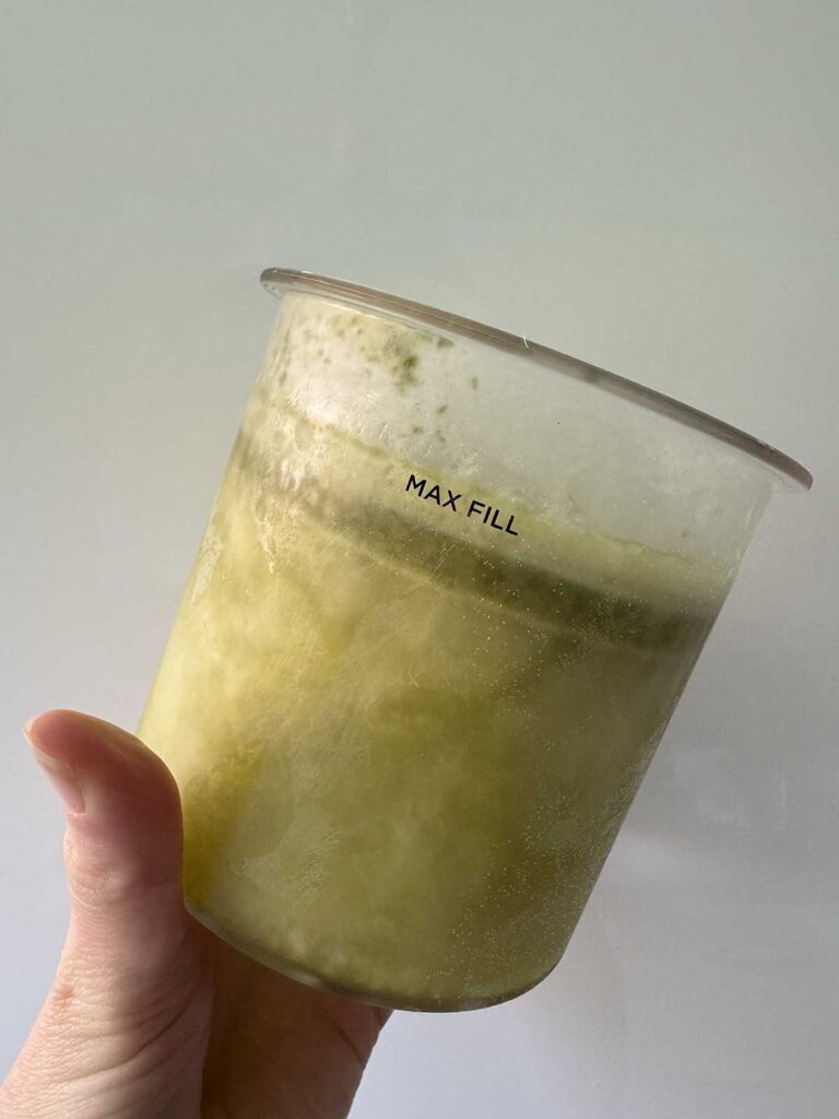 Frozen lemon basil sorbet in Creami container