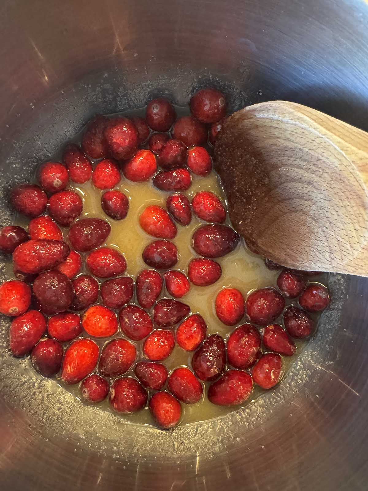 Uncooked cranberries in a pot.