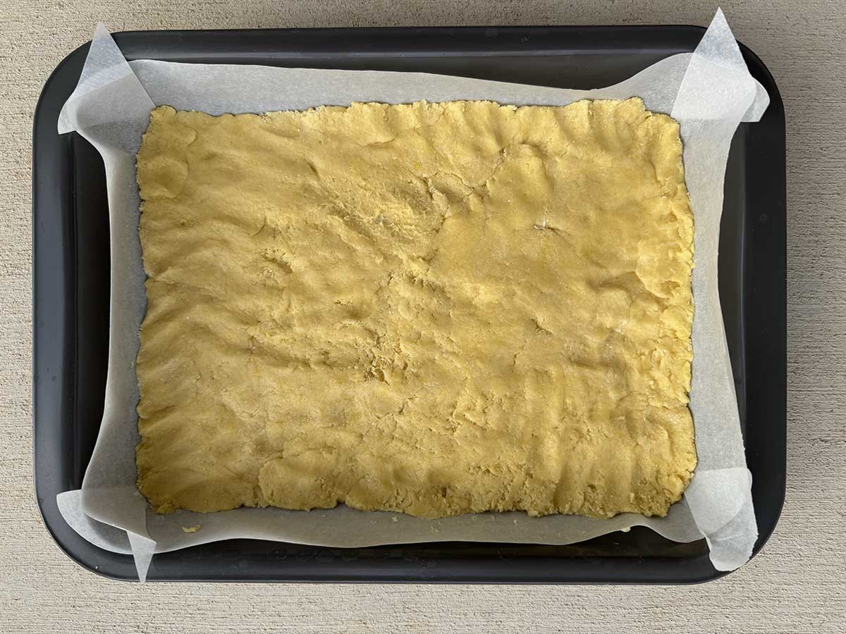 Bottom layer of lemon chess bars pressed down