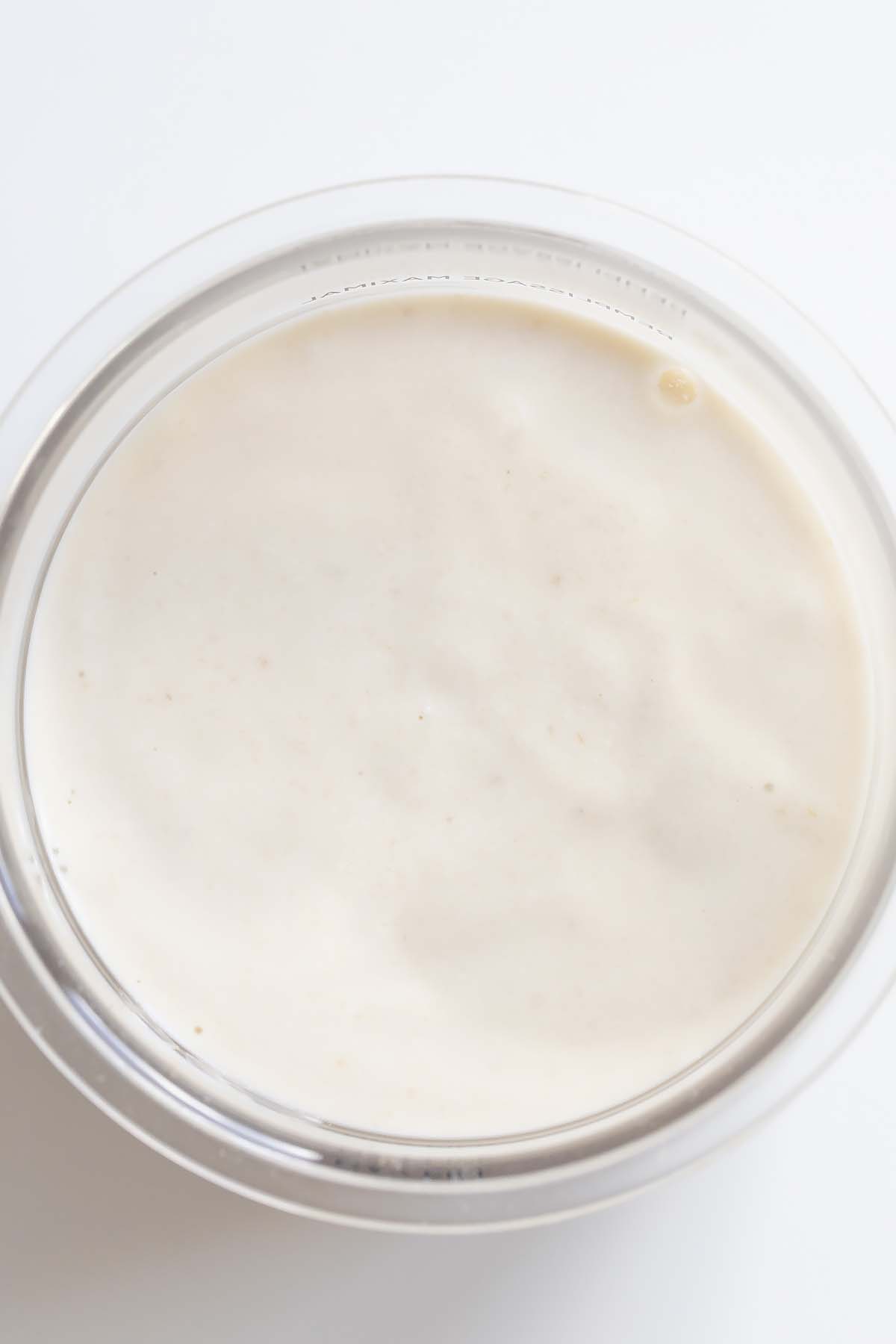 Blended banana ice cream mixture in Ninja Creami