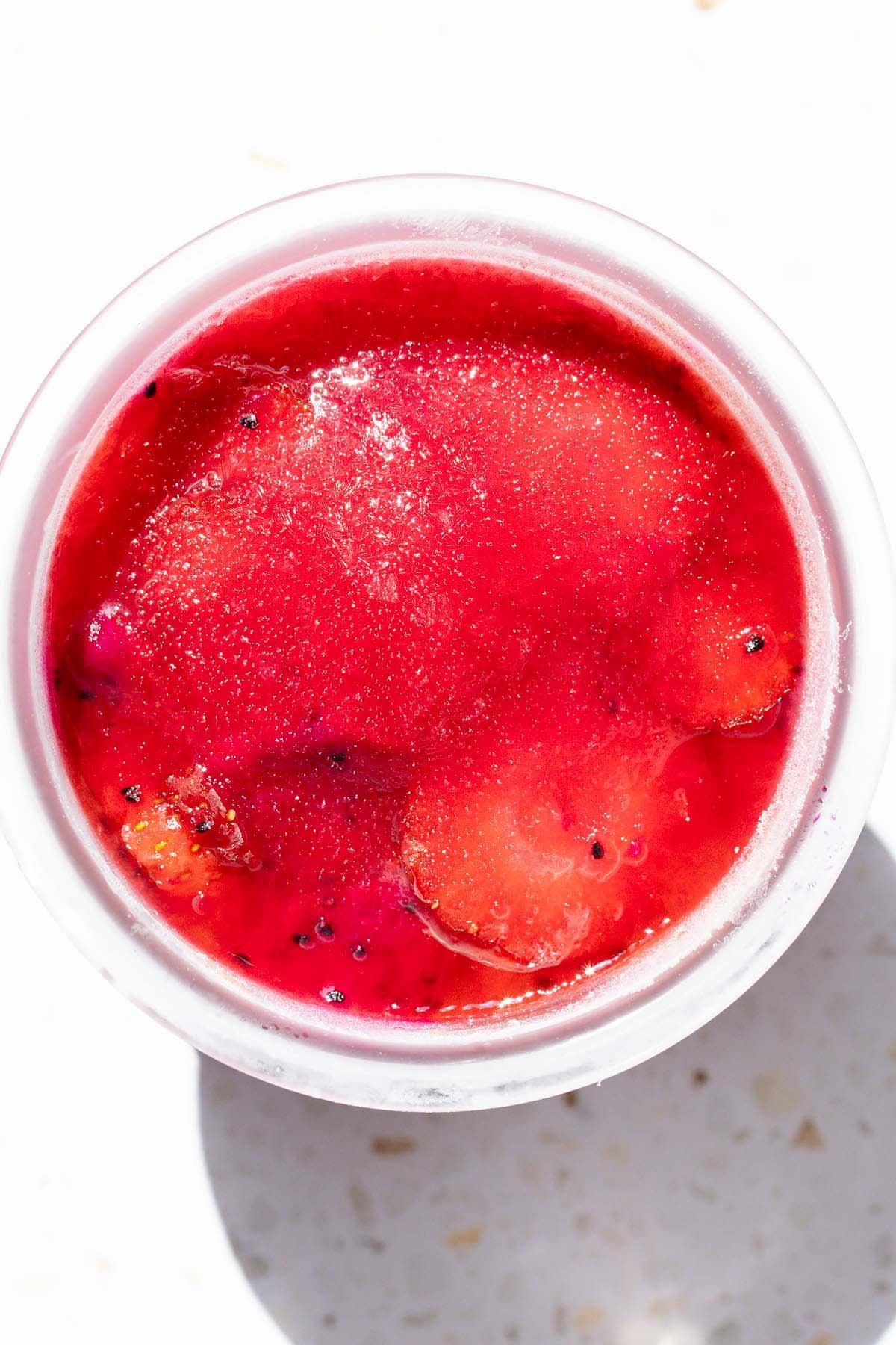 Frozen dragon fruit sorbet in Ninja Creami container