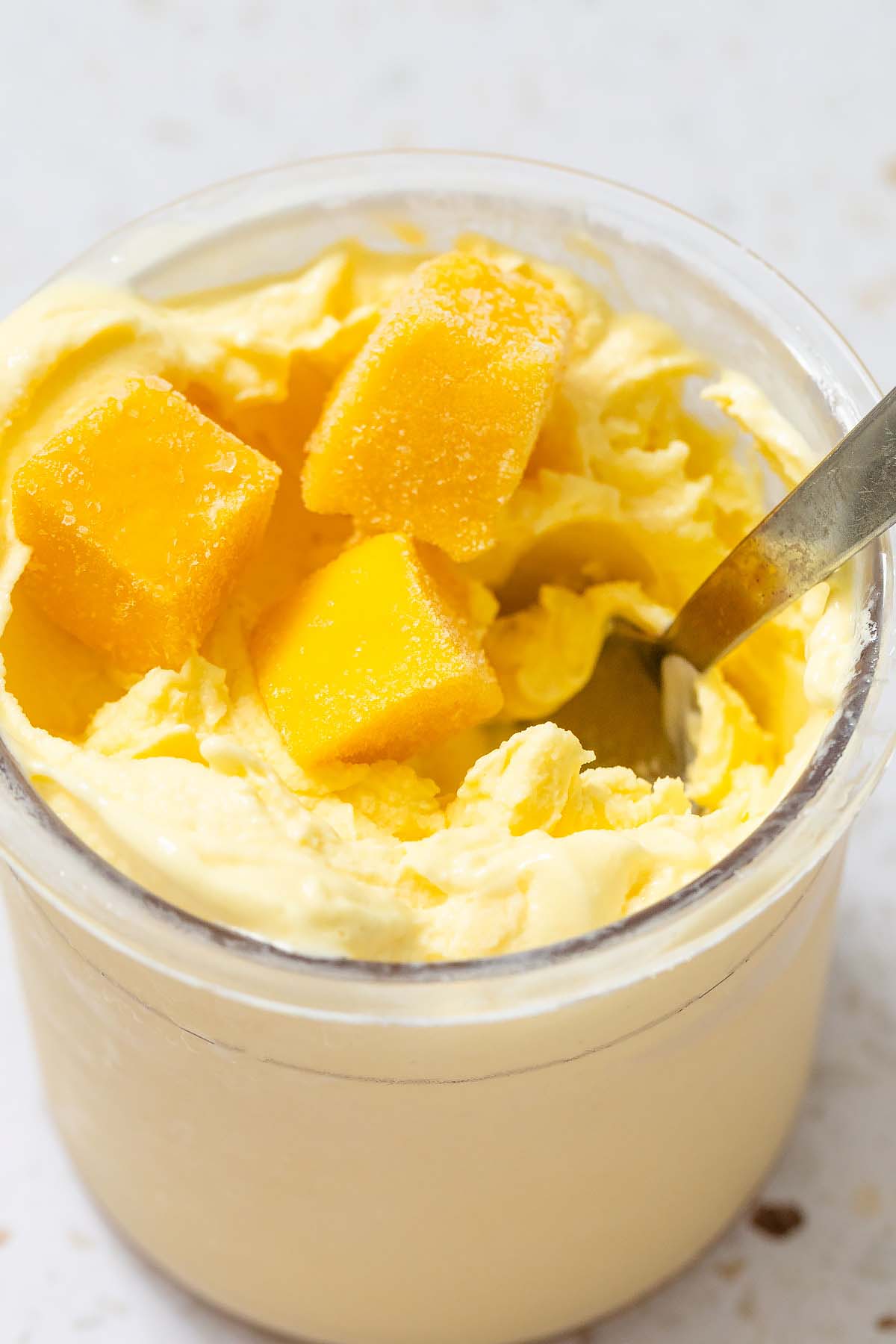 Ninja Creami mango frozen yogurt with mango pieces on top