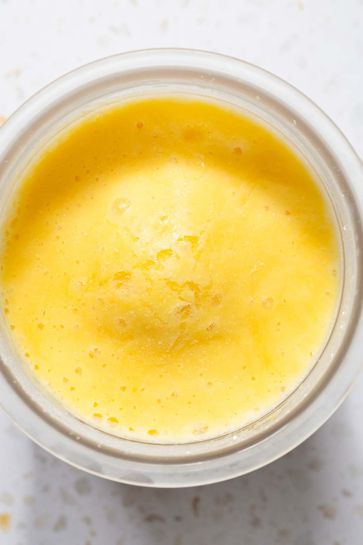 Frozen mango yogurt in Ninja Creami container