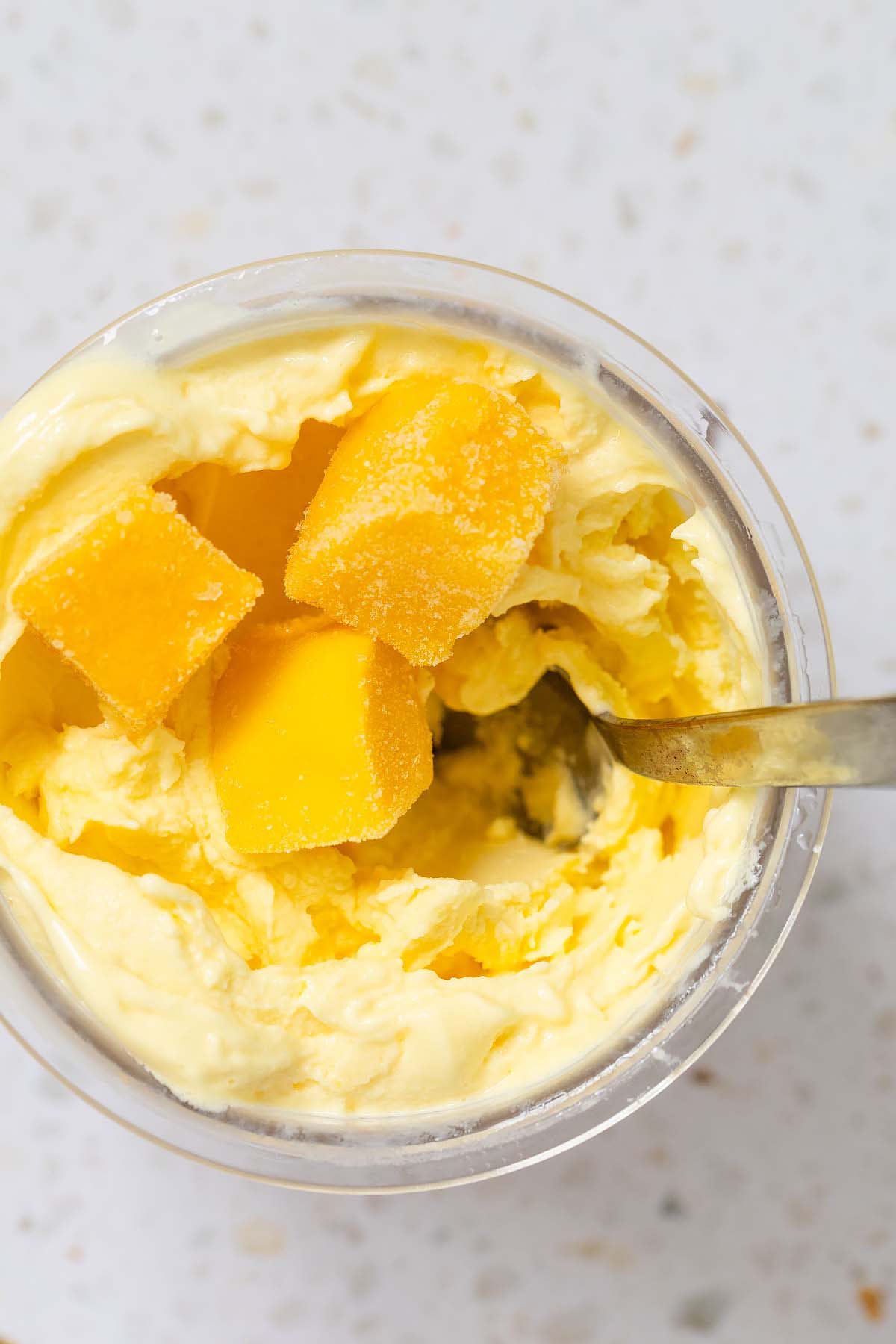 Ninja Creami mango frozen yogurt with mango pieces on top