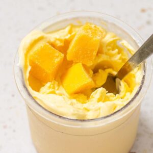 Ninja Creami mango frozen yogurt with mango pieces on top