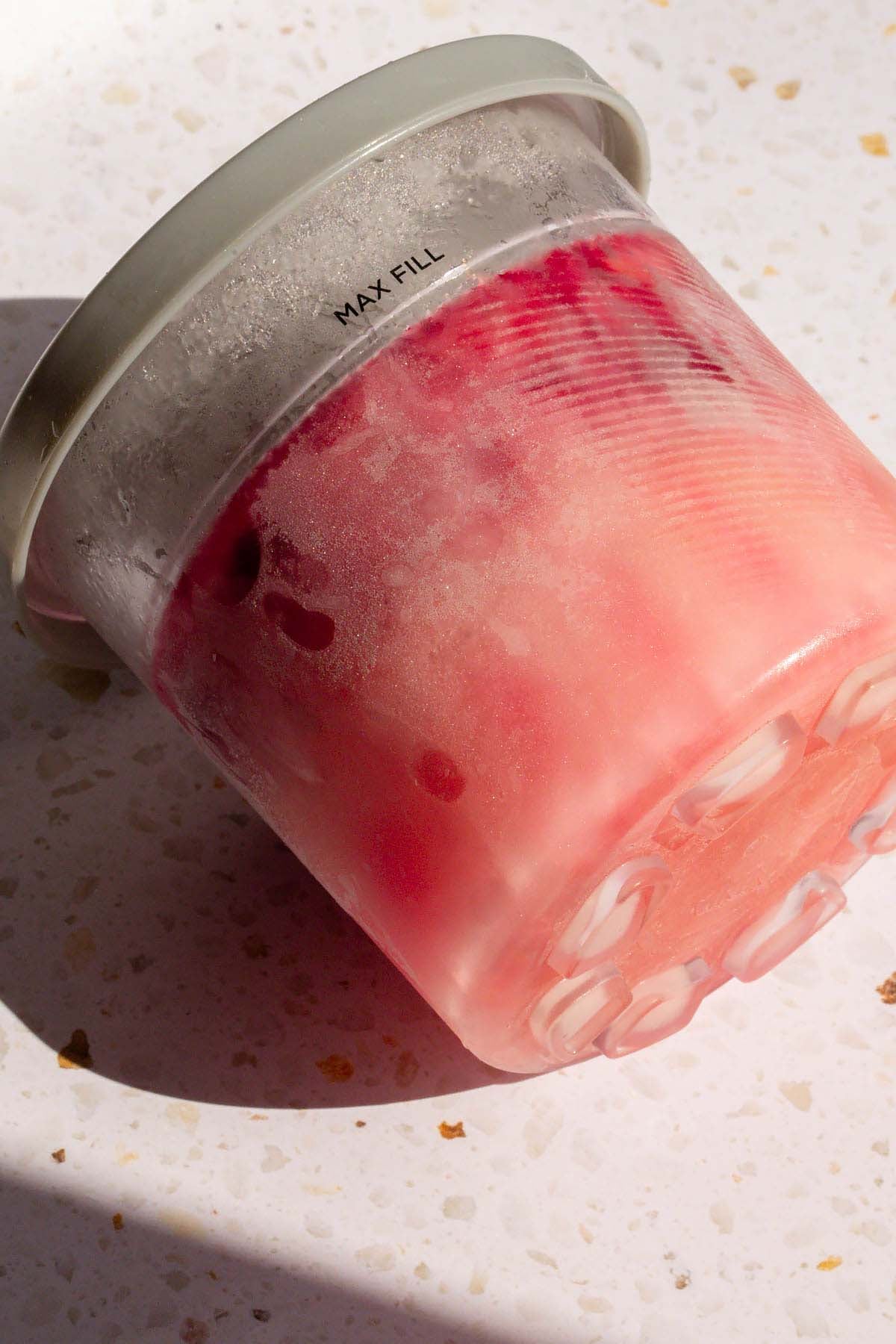 Frozen cherry lime sorbet in Ninja Creami container