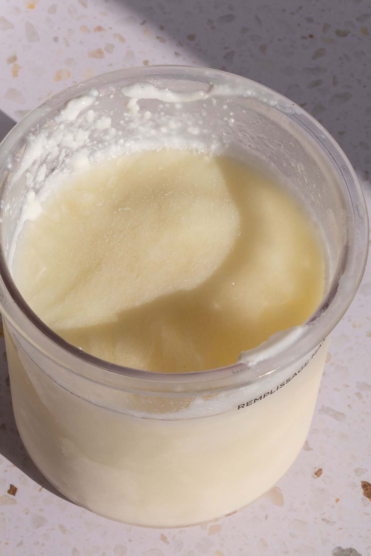 Frozen ice cream in Ninja Creami container