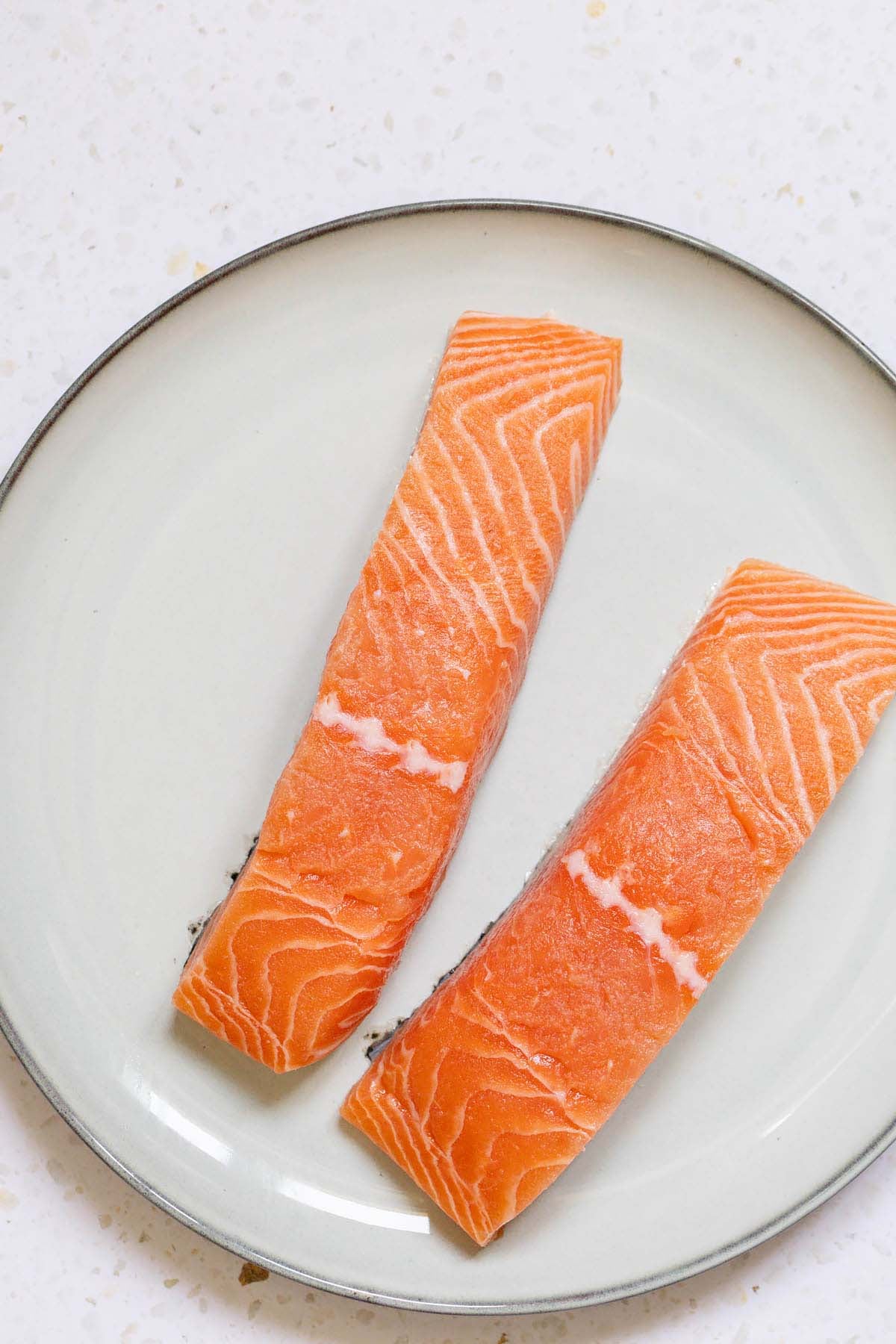 Raw salmon fillets on a plate