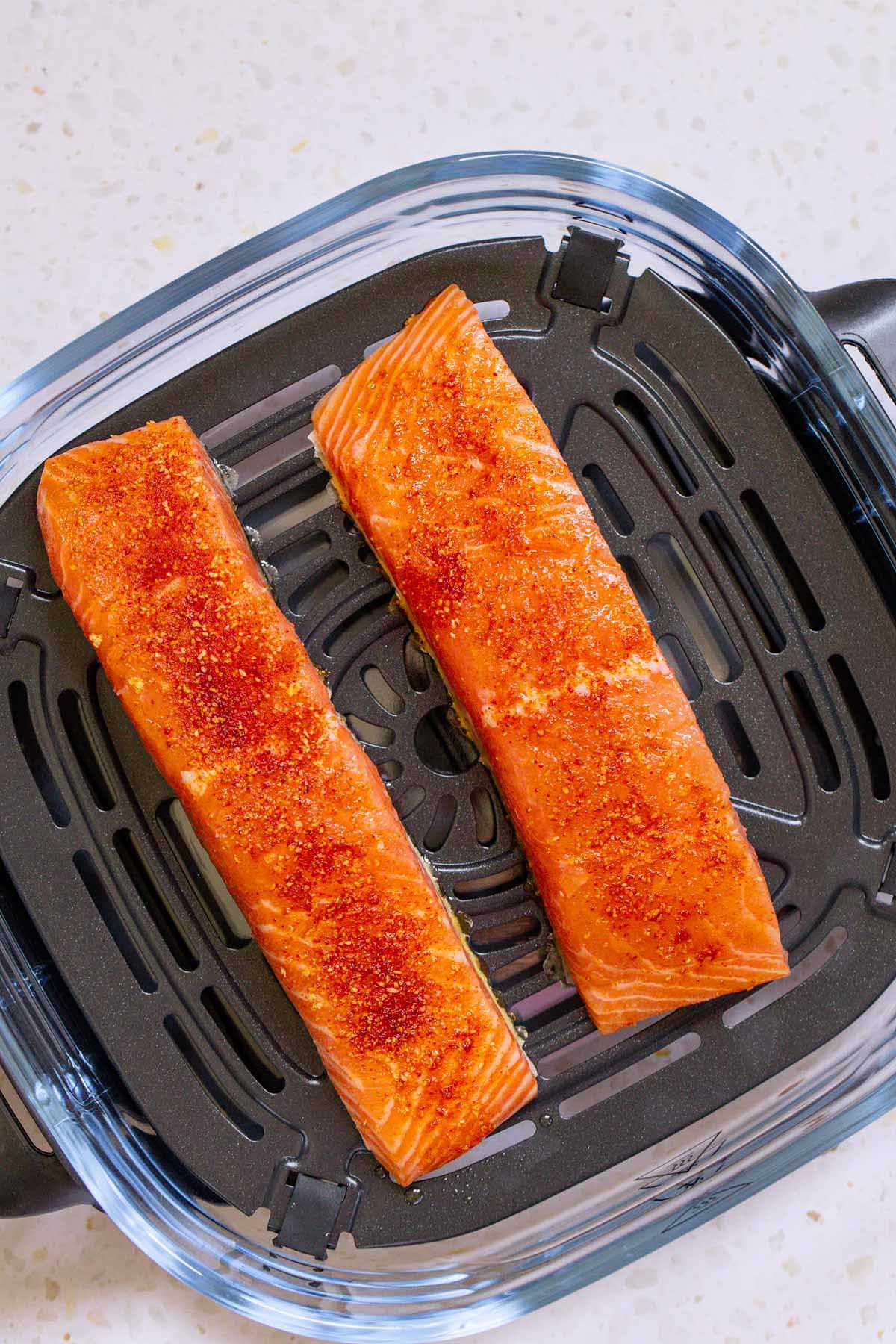 Uncooked salmon in Ninja Crispi container
